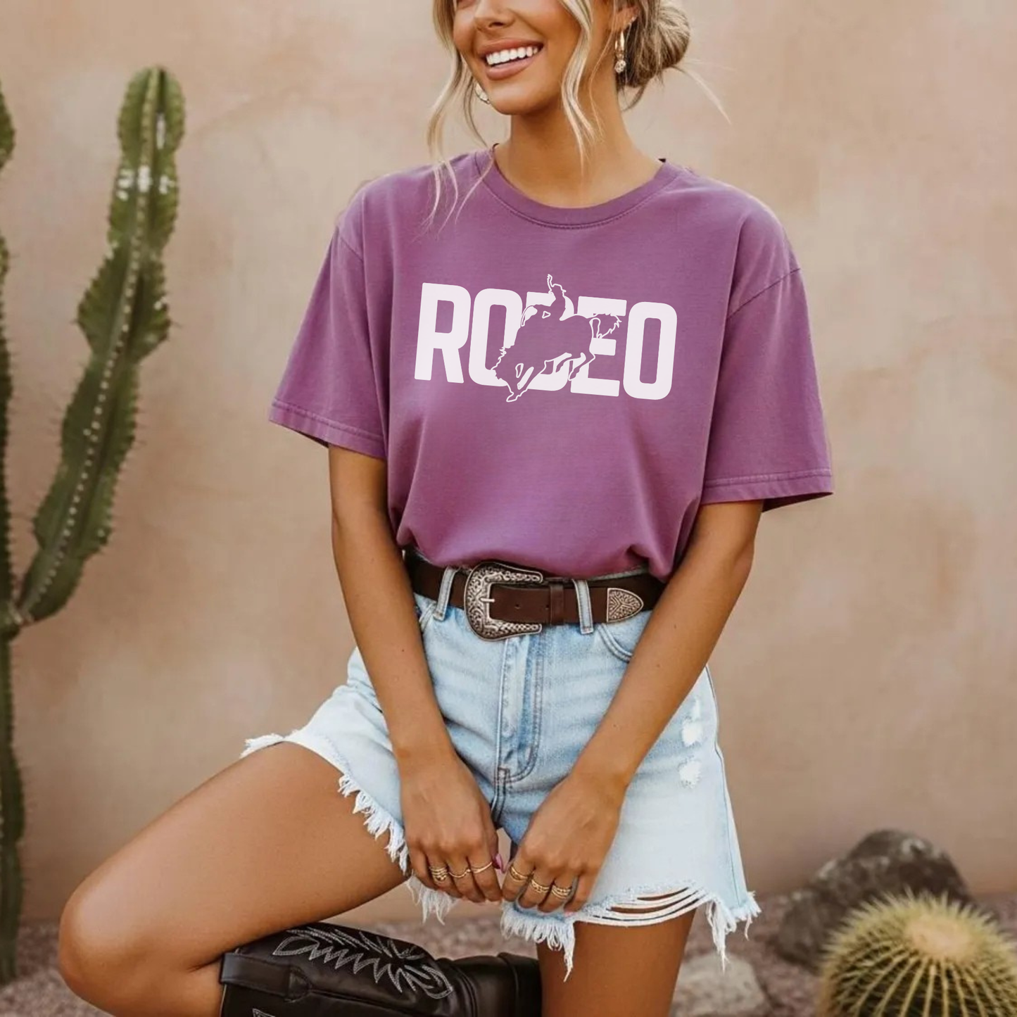Purple rodeo graphic t shirt styled with denim shorts and cowboy boots
