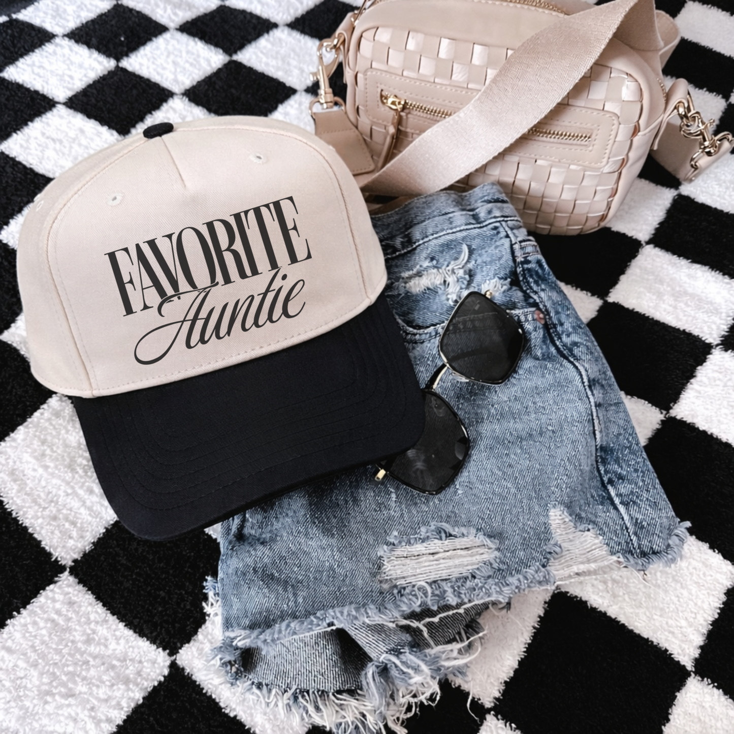 Favorite Auntie hat black and canvas structured trucker hat flat lay