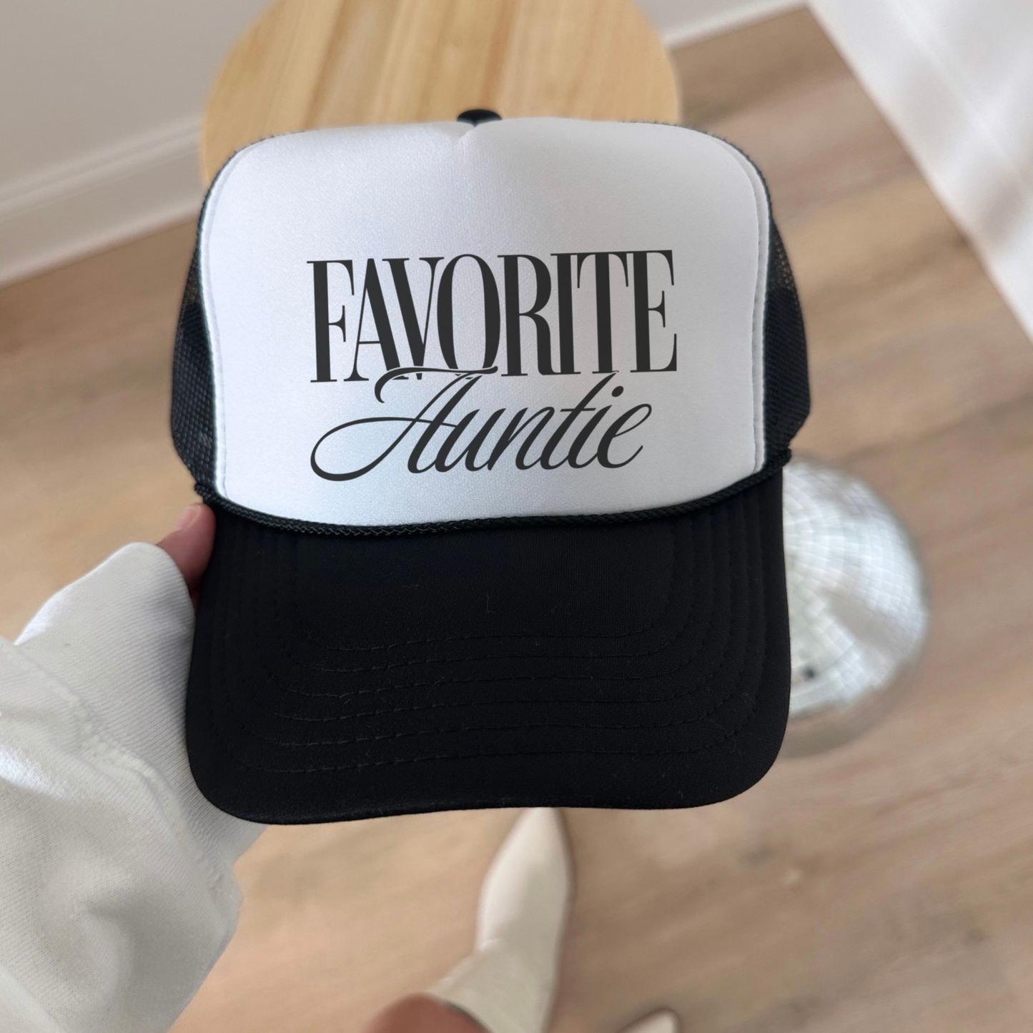 Favorite Auntie hat black and canvas structured trucker hat flat lay