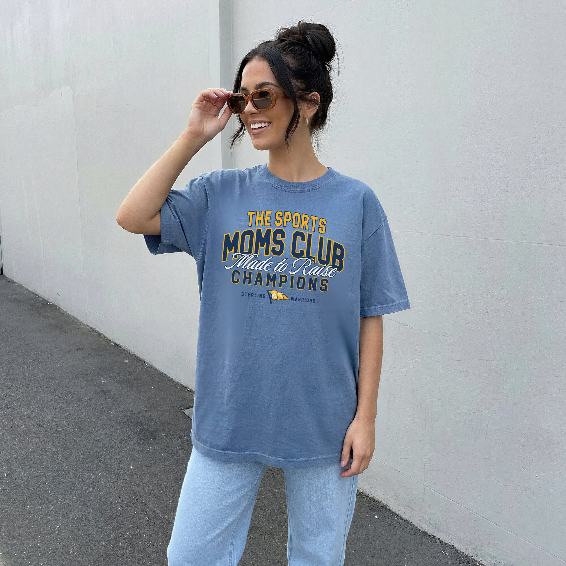 sports moms club sterling warriors t-shirt blue vintage graphic worn by woman casual baseball game day outfit