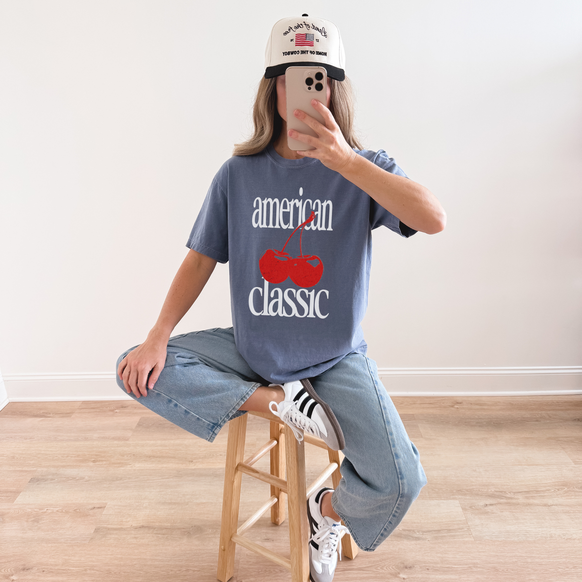 Woman wearing blue jean ‘American Classic’ T-shirt with red cherry print and casual denim outfit