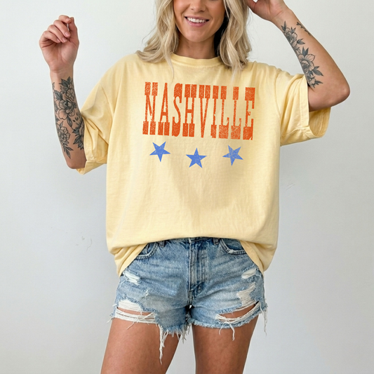 Woman wearing butter yellow Nashville graphic t-shirt with distressed lettering and stars casual summer outfit
