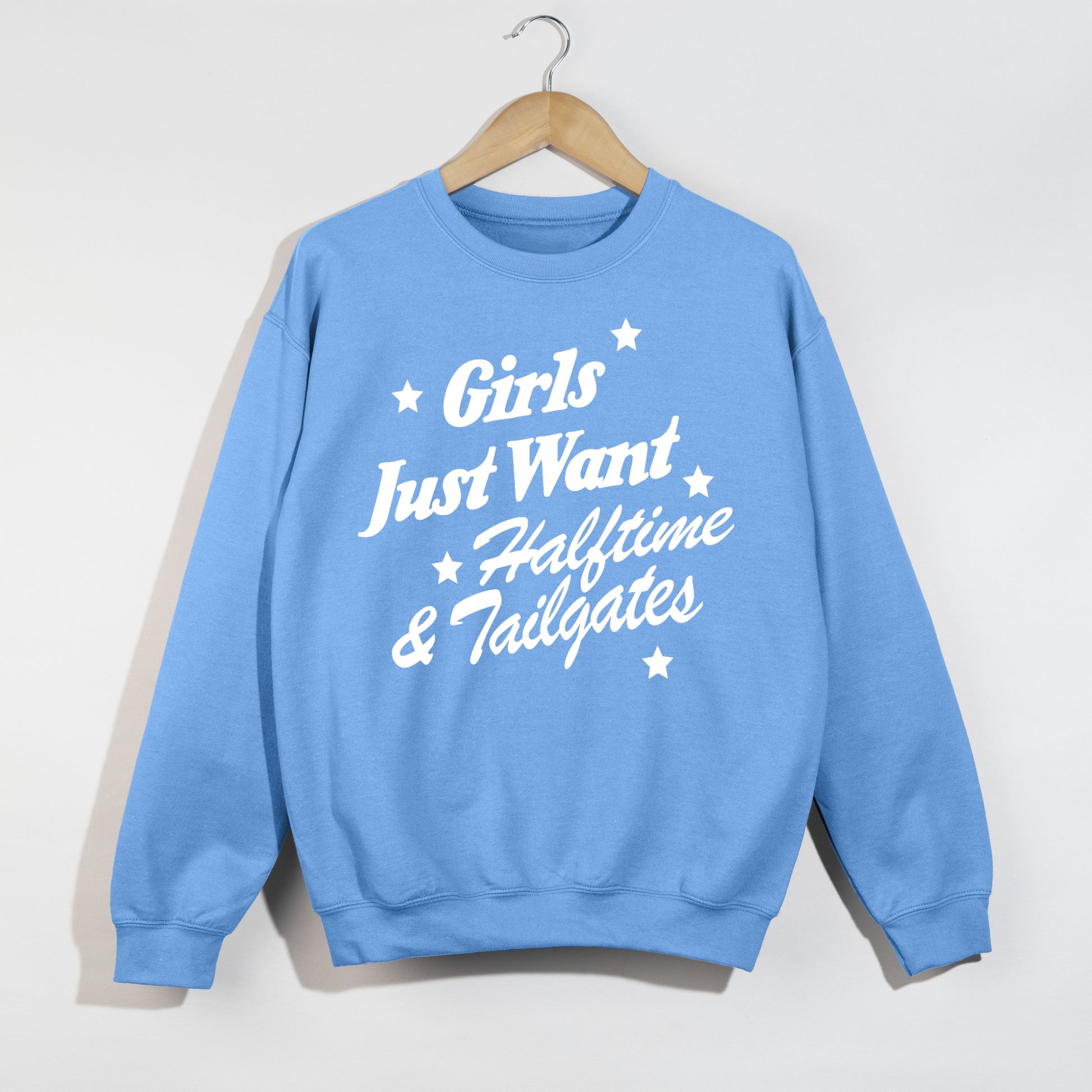 Carolina blue graphic crewneck sweatshirt featuring "Girls Just Want Halftime & Tailgates" football season design.