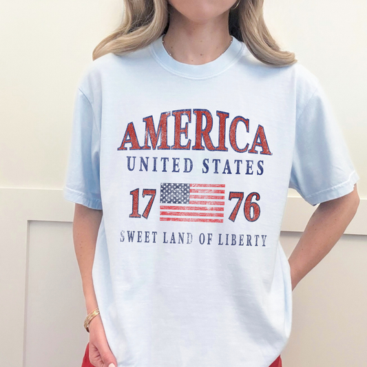 Model wearing America 1776 patriotic USA graphic tee styled casually