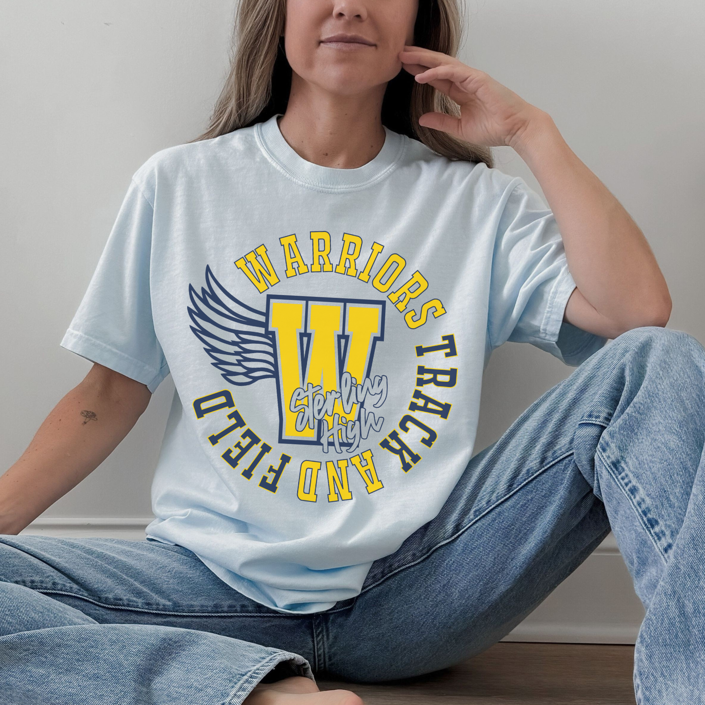 Sterling High School Warriors Track and Field t-shirt styled casually in light blue unisex fit