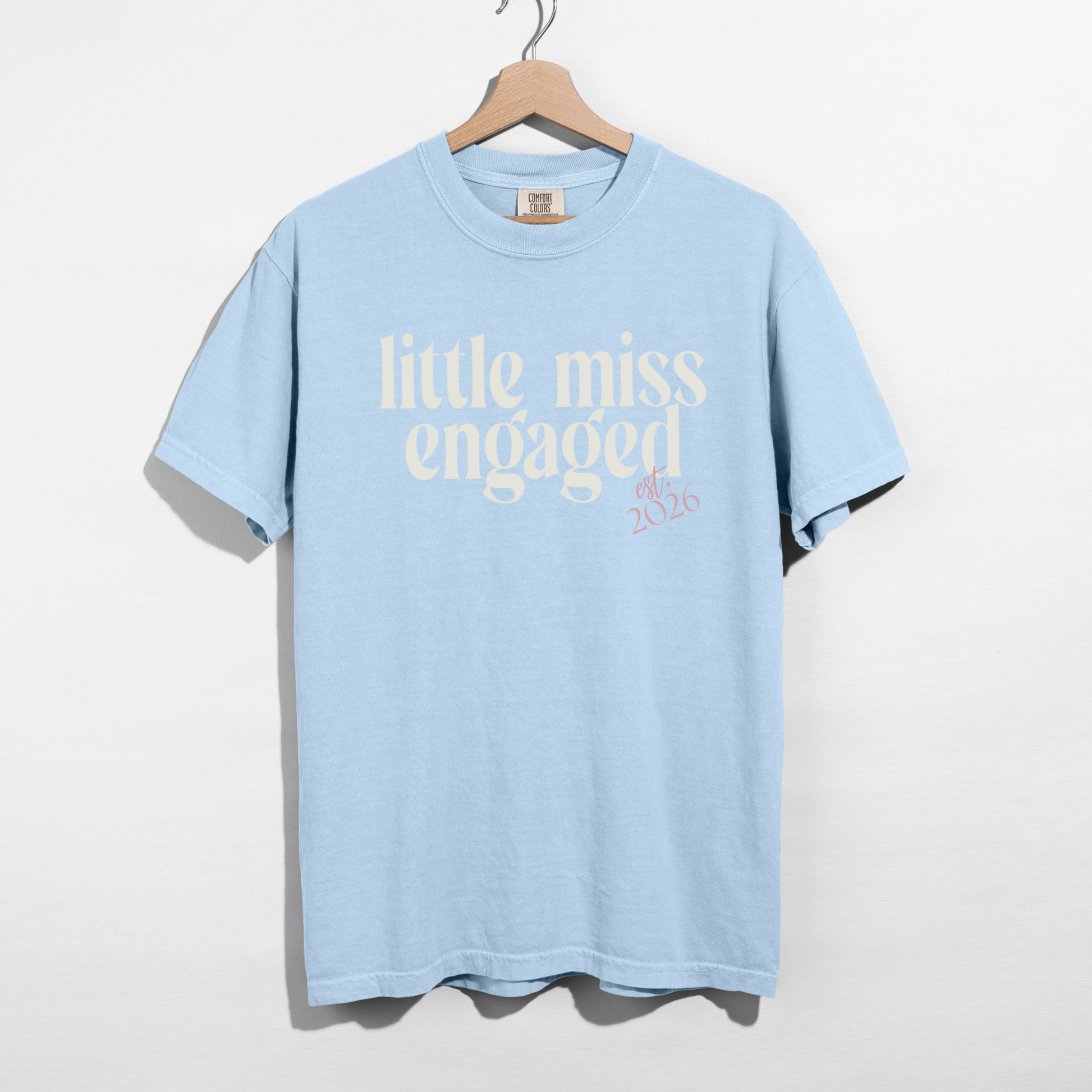 Light blue Little Miss Engaged Est. 2026 bridal t-shirt on hanger