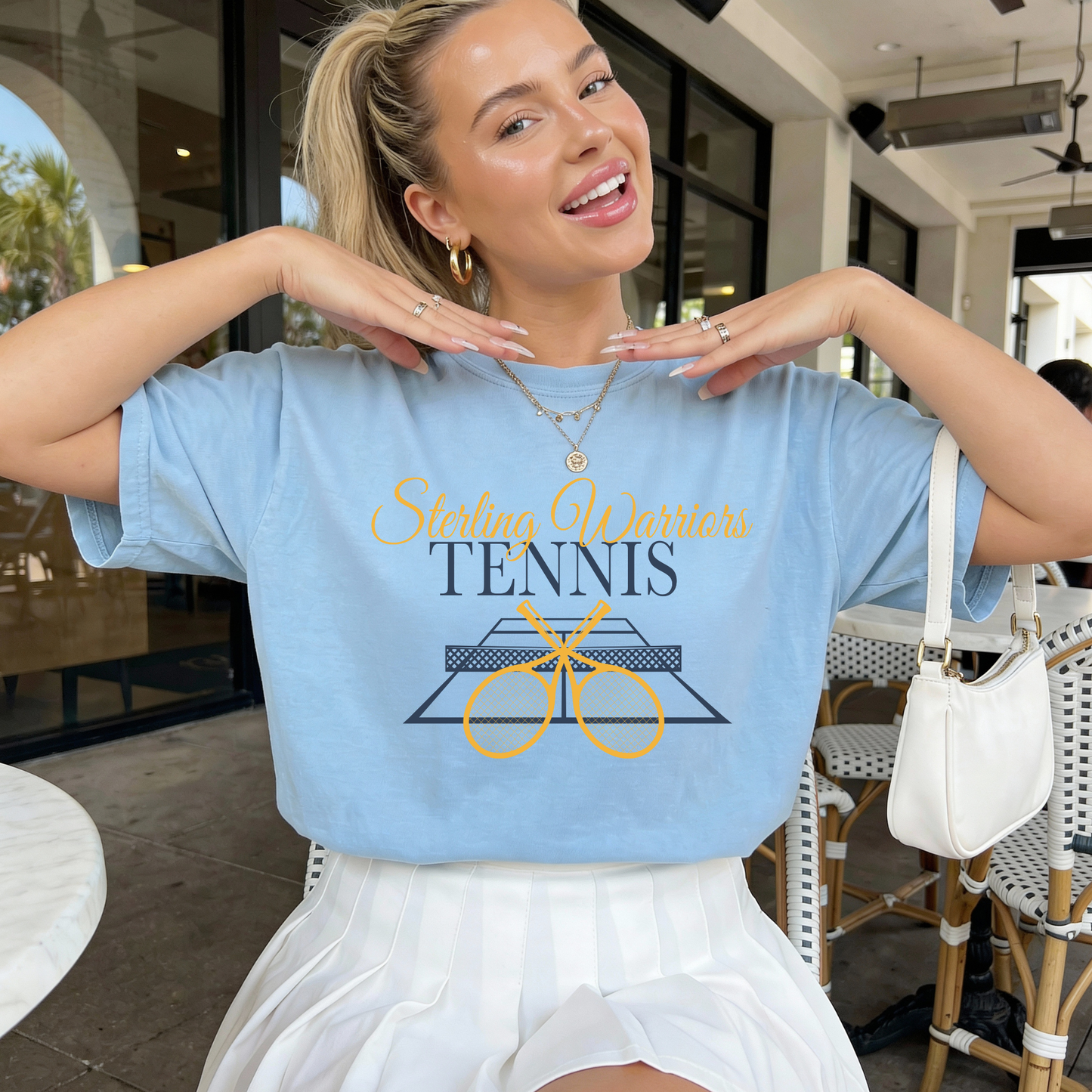 Sterling Warriors Tennis graphic tee styled with pleated skirt for sporty school spirit look