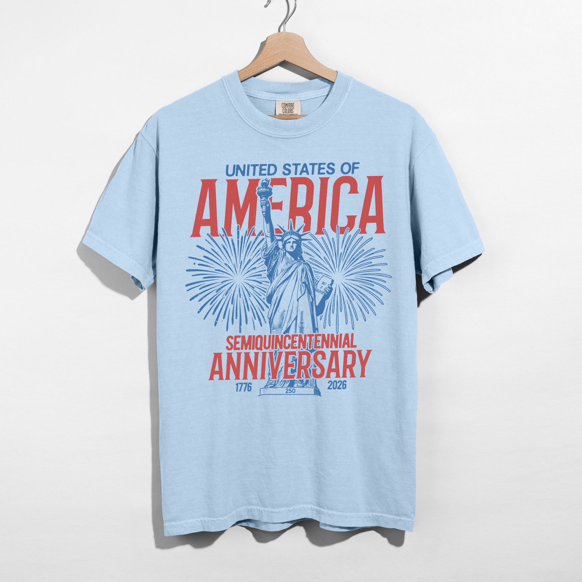 Light blue vintage America fireworks graphic shirt hanging on hanger patriotic summer shirt