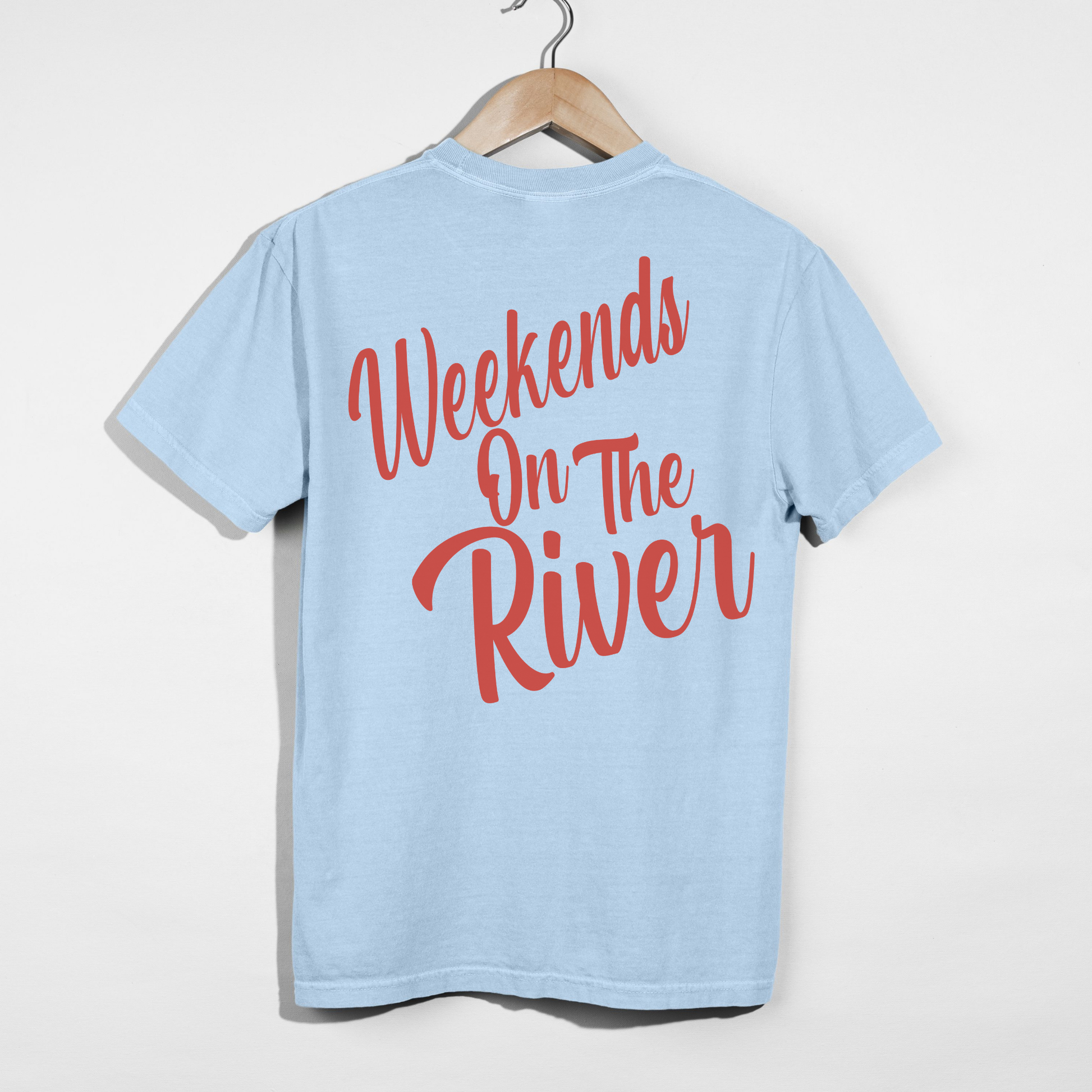 Chambray blue Comfort Colors t-shirt with bold coral “Weekends On The River” river life graphic printed on back.
