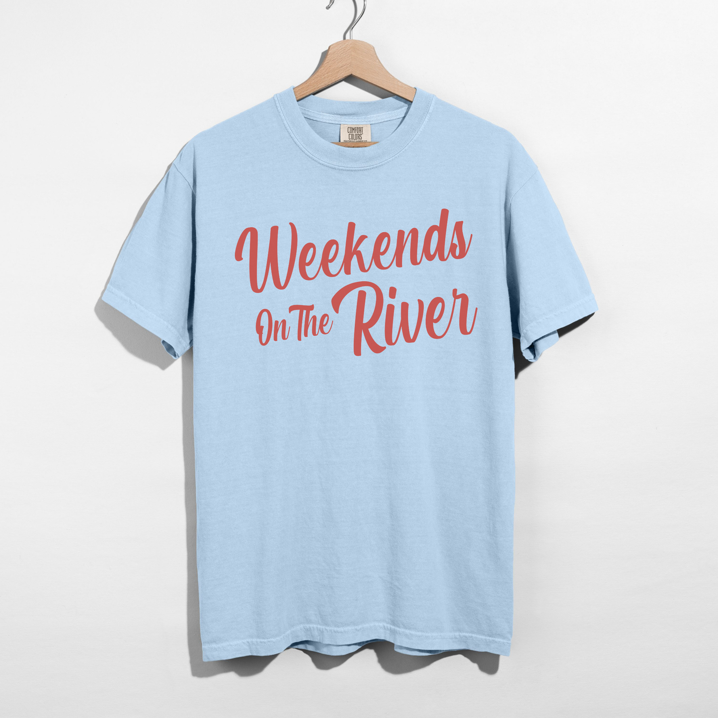 Chambray Comfort Colors lake t-shirt with coral red “Weekends On The River” script design on front.