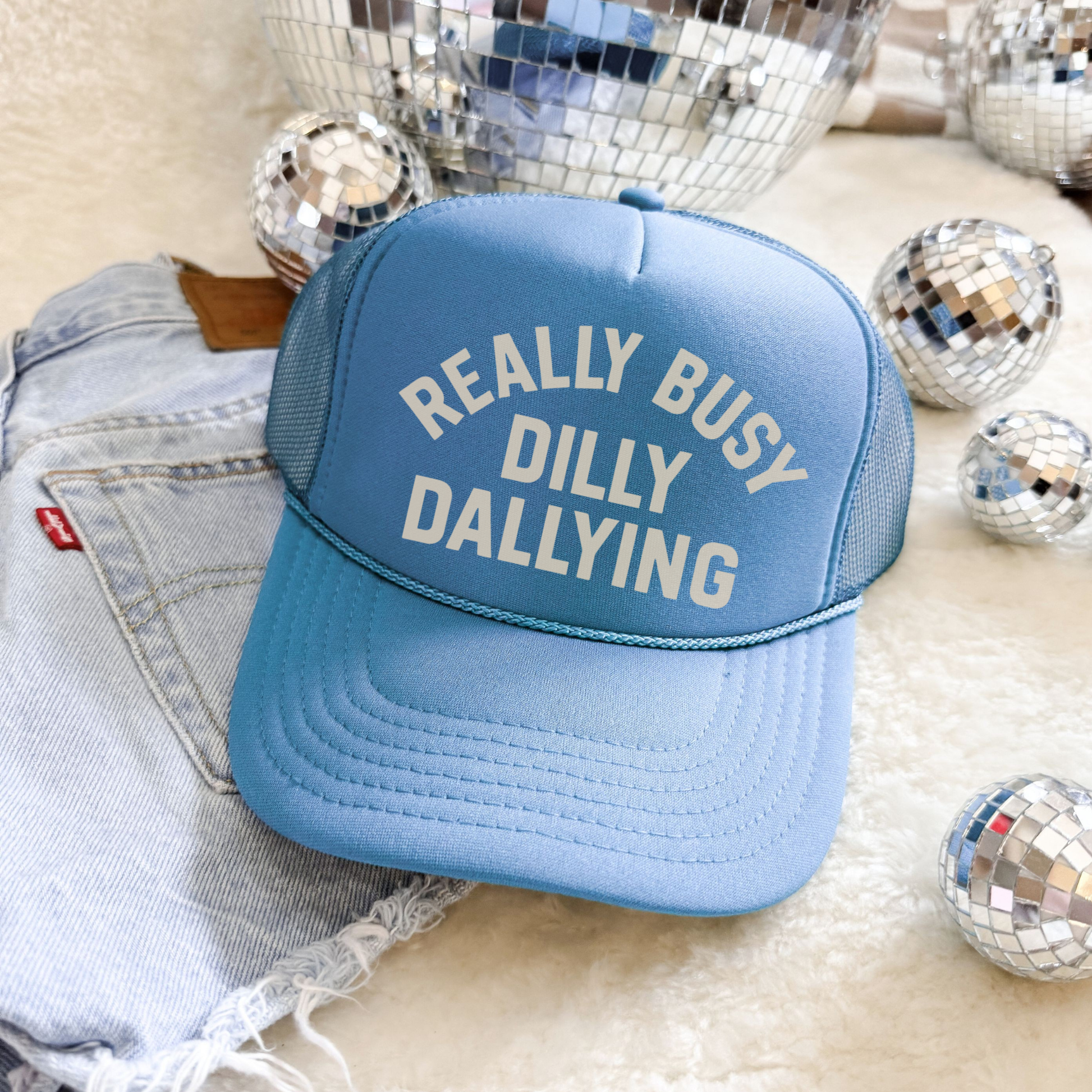 Really Busy Dilly Dallying foam trucker hat styled with denim and disco ball decor