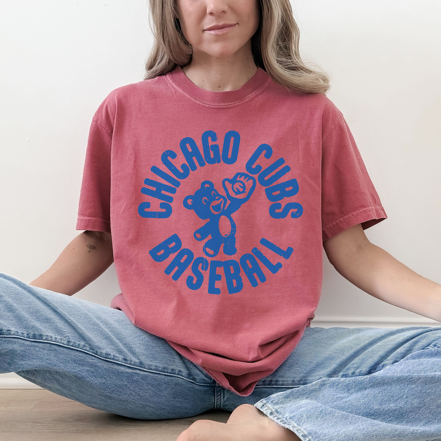 Woman wearing crimson vintage Chicago Cubs Baseball graphic tee with blue collegiate lettering and retro cub design.