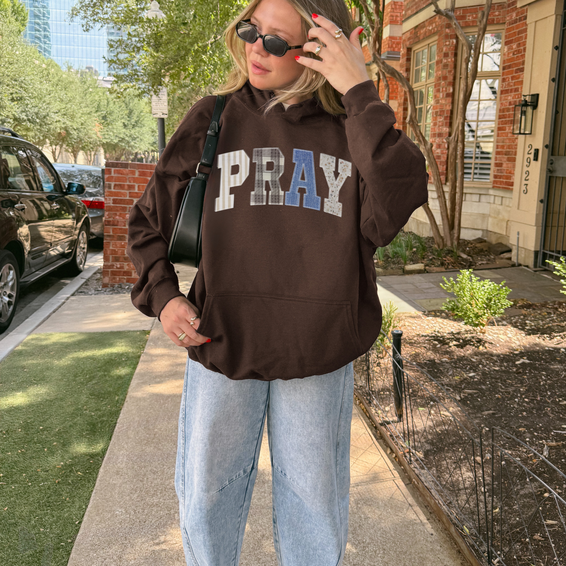 PRAY patchwork hoodie front view on model in brown hoodie with relaxed fit