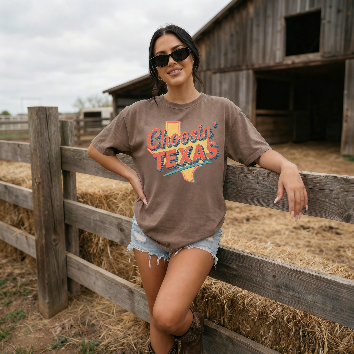 Woman wearing brown Choosin Texas western graphic tee with cowboy boots at ranch