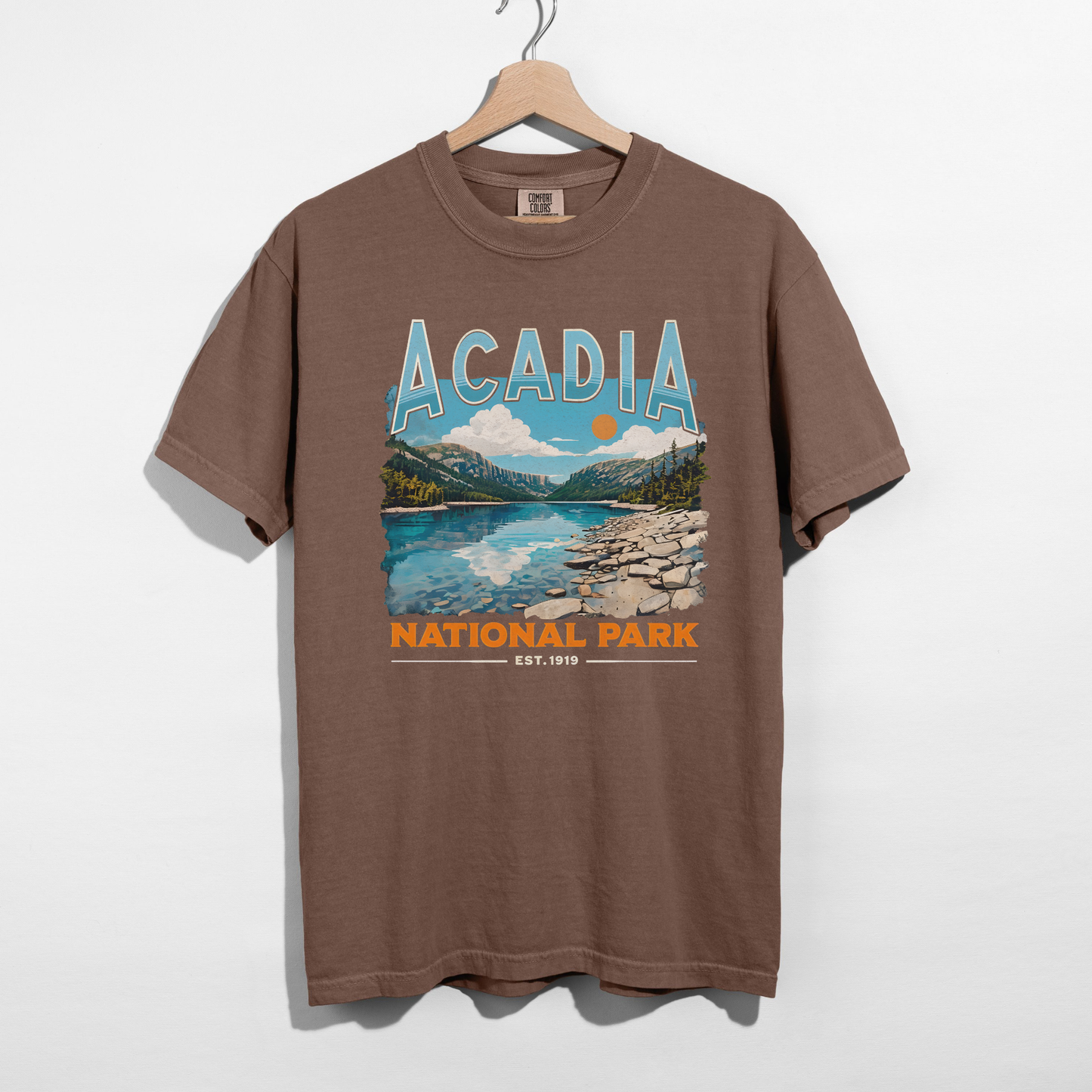 Espresso brown Acadia National Park vintage travel graphic t-shirt with bold retro typography and national park artwork.