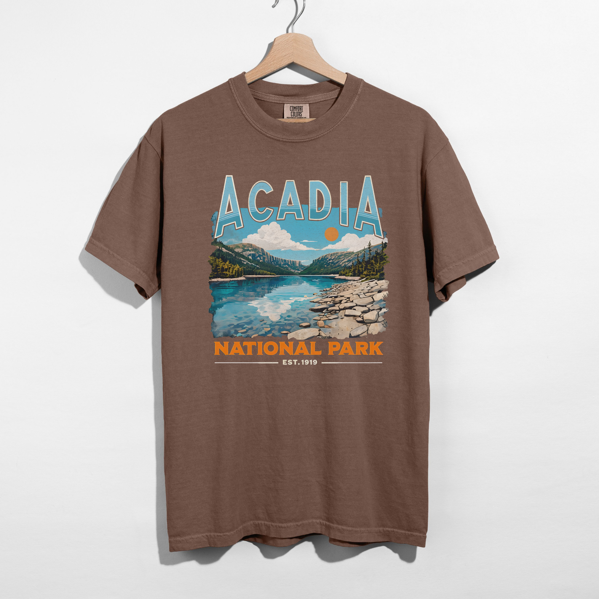 Espresso brown Acadia National Park vintage travel graphic t-shirt with bold retro typography and national park artwork.