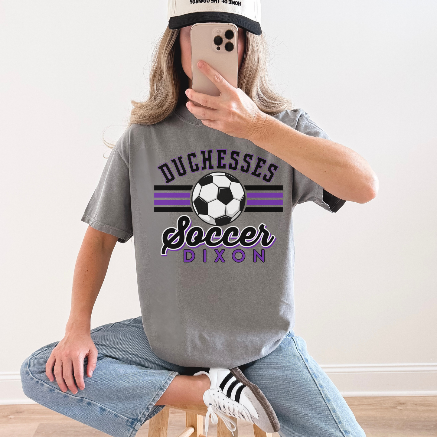 Woman wearing oversized grey Duchesses Soccer Dixon t-shirt with casual outfit
