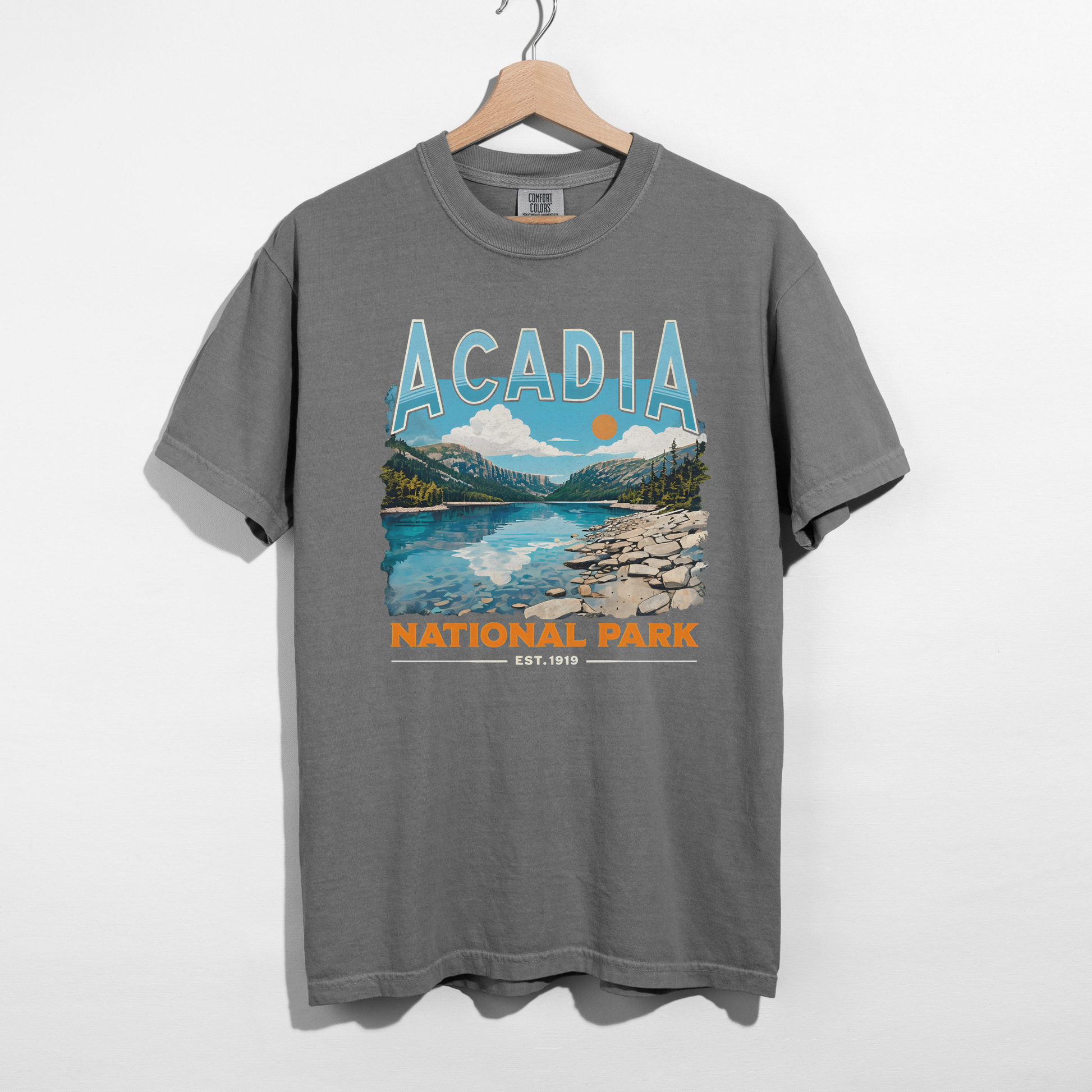 Grey Acadia National Park scenic landscape graphic t-shirt featuring mountain, lake, and sunset illustration.