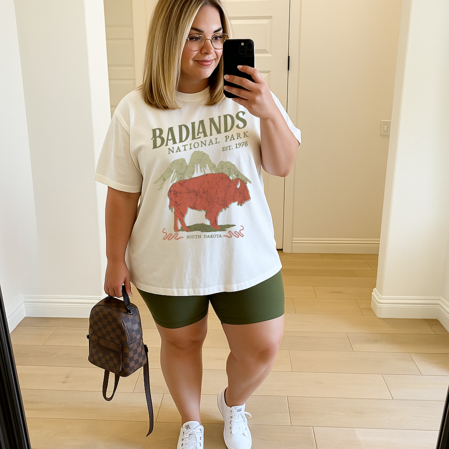 Woman wearing ivory Badlands National Park graphic tee in size 2X