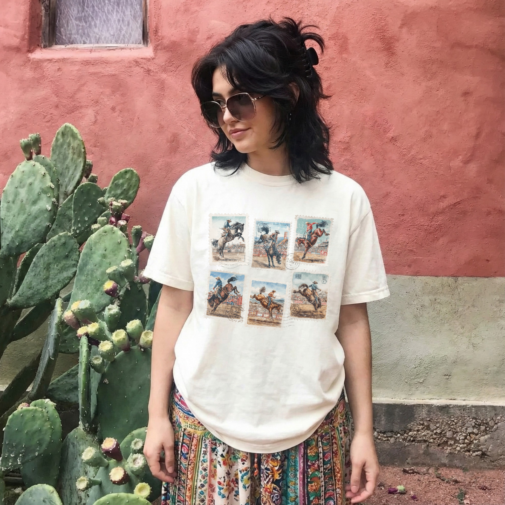 Woman wearing western rodeo stamp graphic tee styled with patterned skirt outdoors