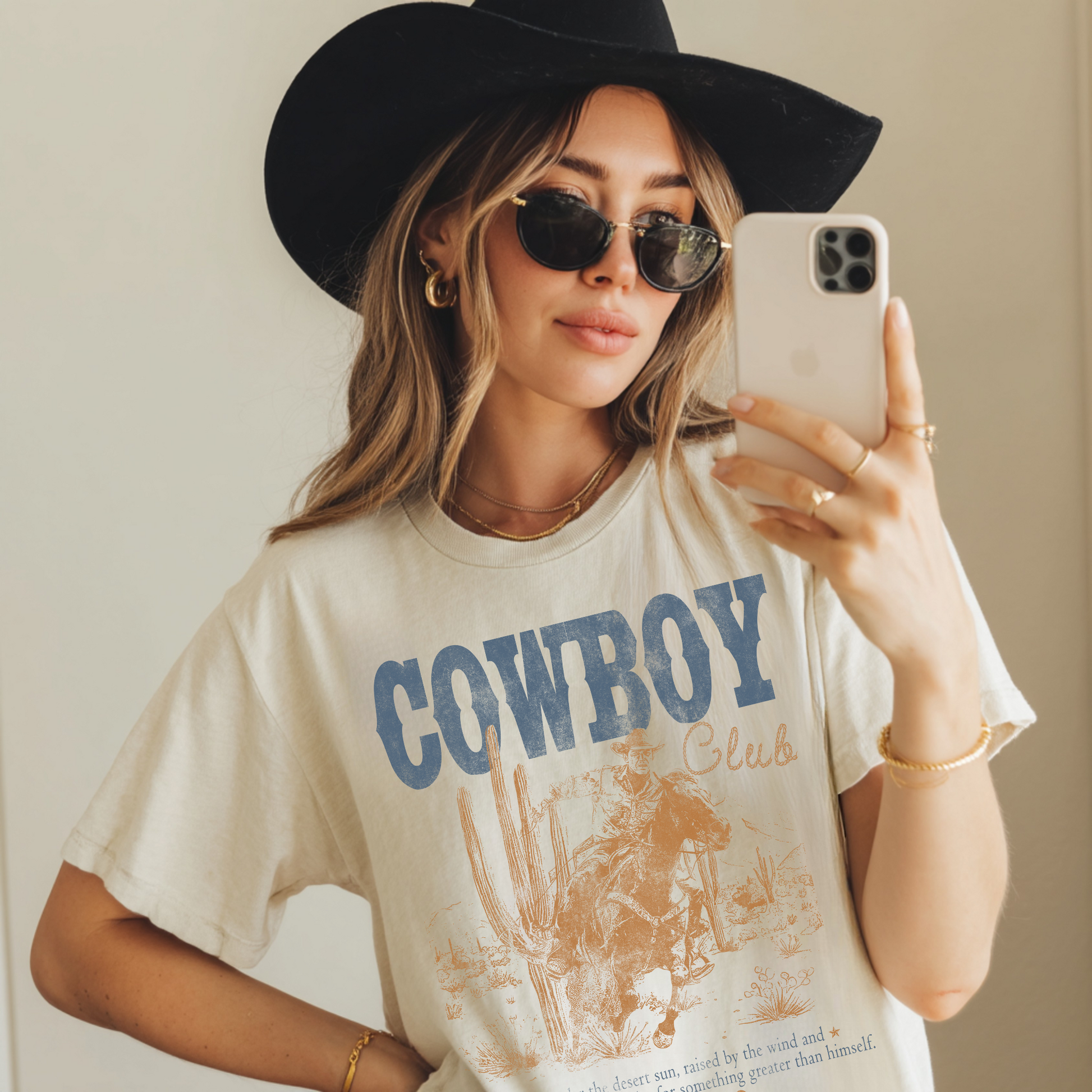 Western cowboy club graphic tee worn by model styled with hat and sunglasses