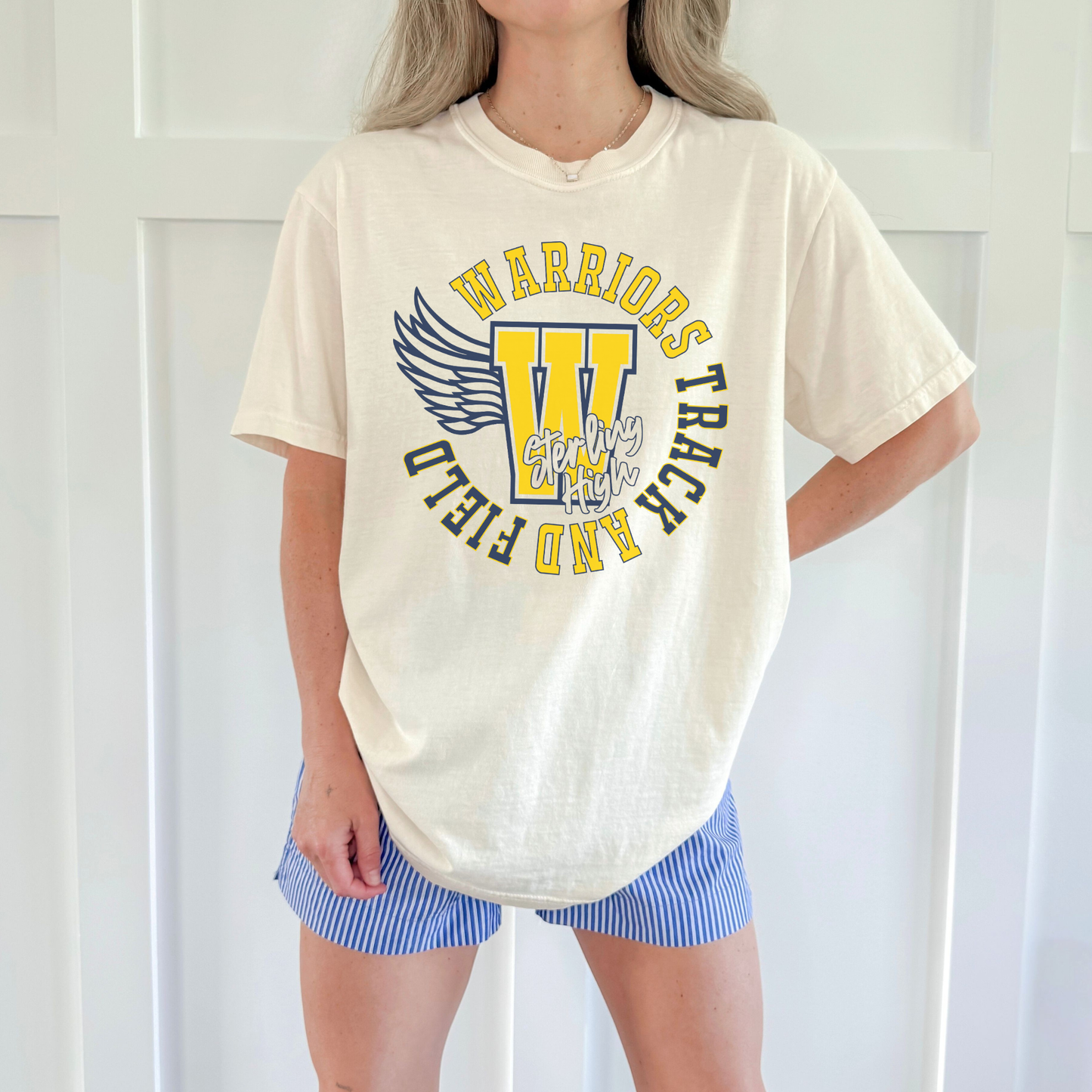 Sterling High School Warriors Track and Field spirit tee in ivory featuring winged W graphic