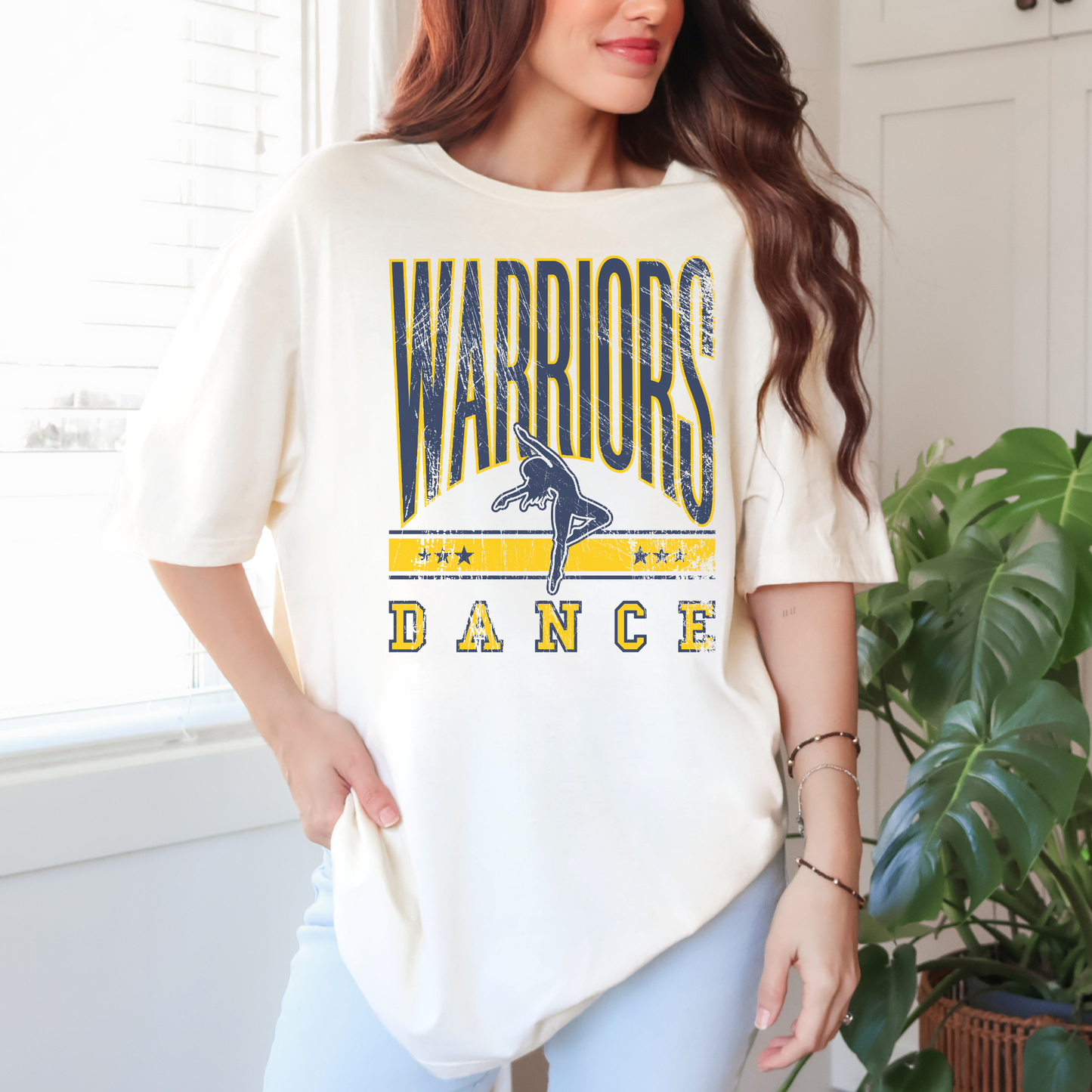 Woman wearing ivory Warriors Dance vintage unisex school spirit t shirt with distressed dancer graphic