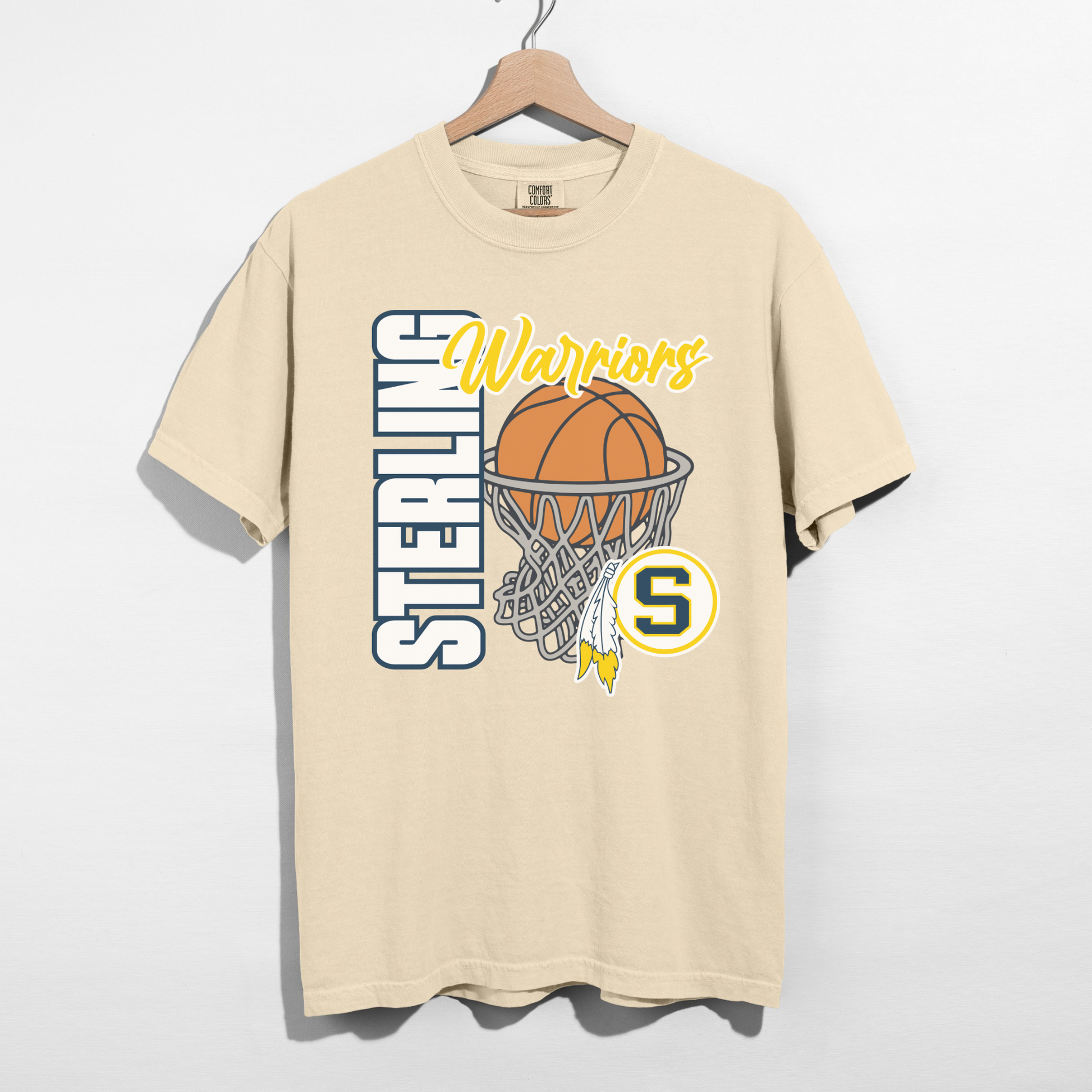 Beige t-shirt with basketball graphic and 'Sterling Warriors' text on a hanger against a white background