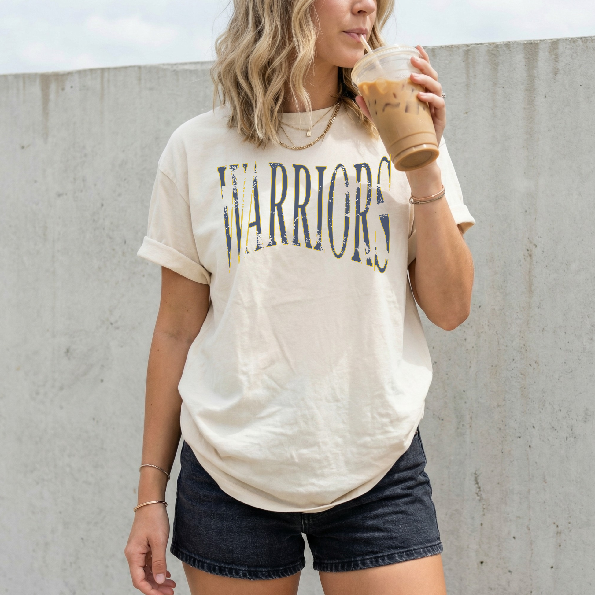 Woman wearing ivory Sterling Warriors distressed arch unisex school spirit t shirt