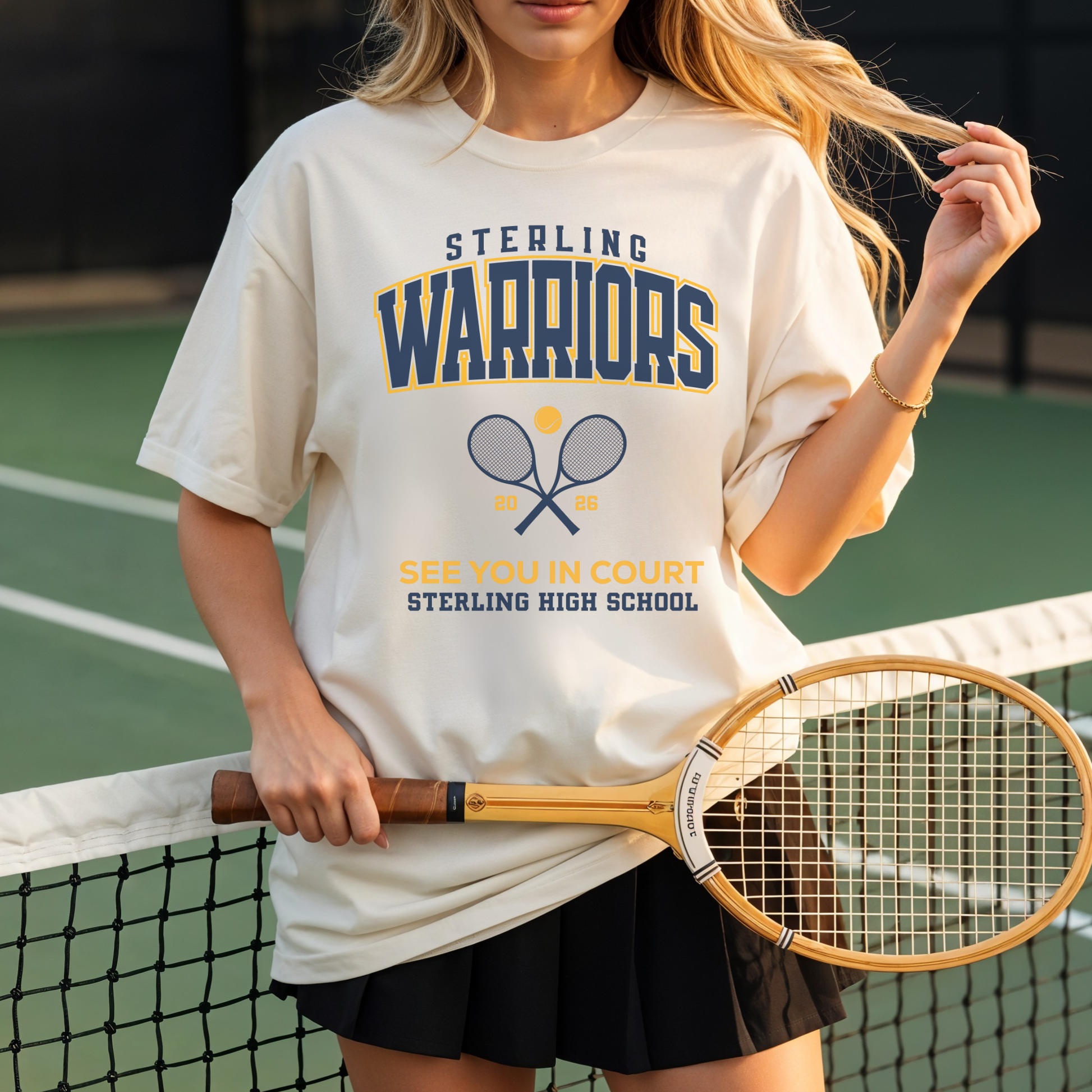 Person wearing a 'Sterling Warriors' t-shirt on a tennis court