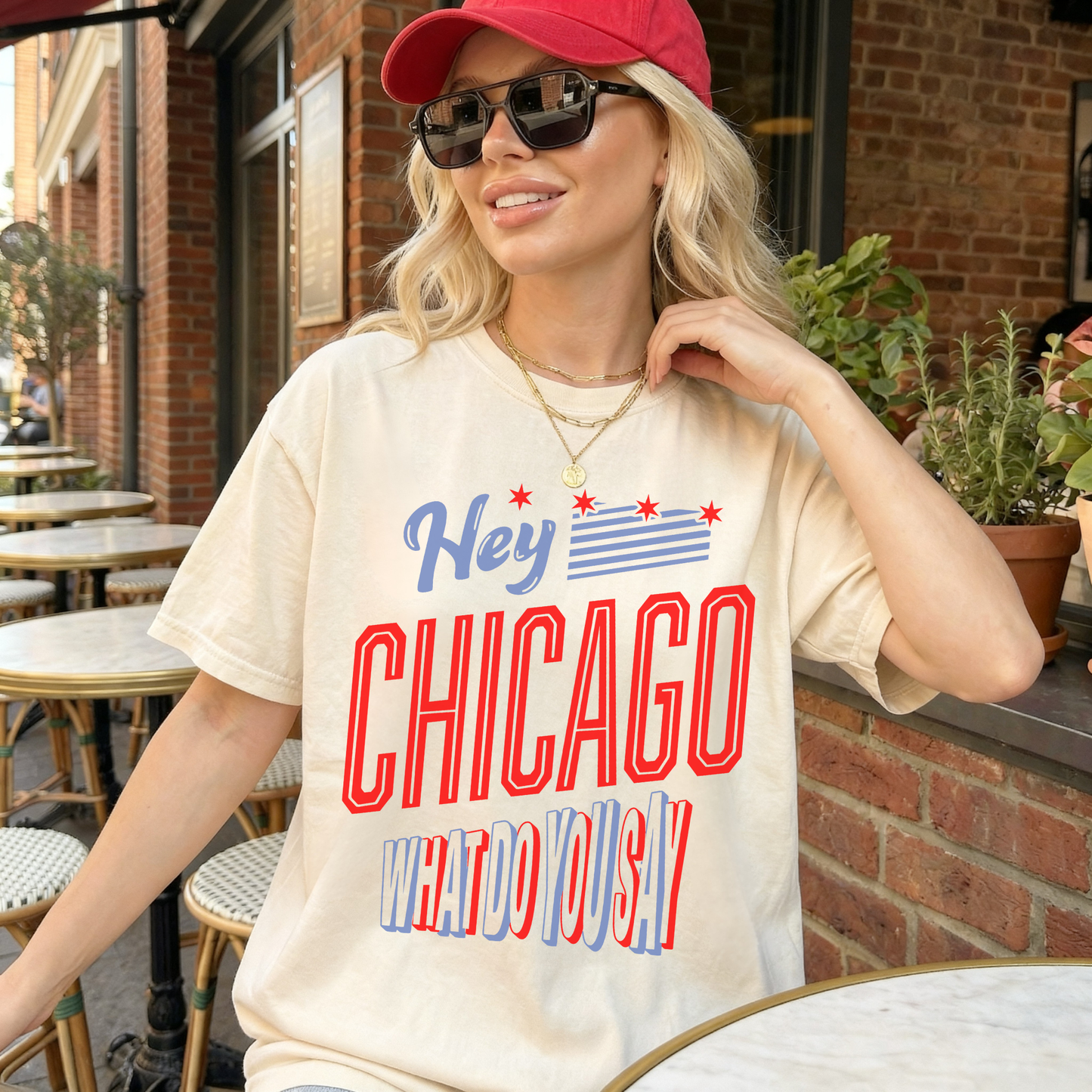 Woman wearing ivory Chicago patriotic graphic tee with skyline flag design and red stars