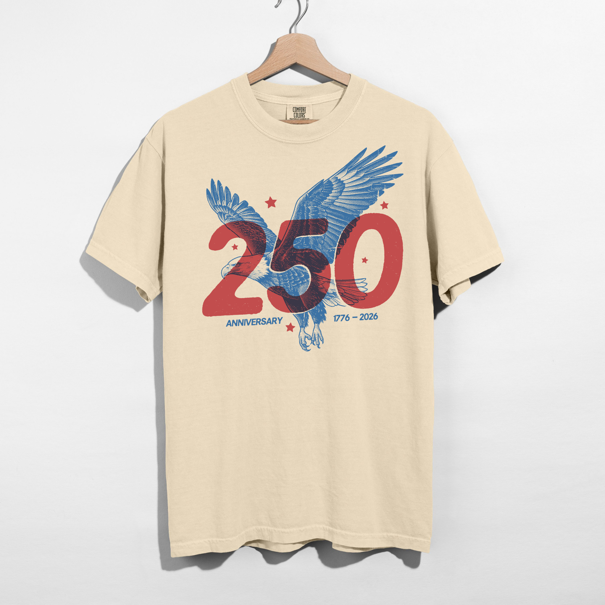 Ivory America 250 eagle anniversary graphic tee with red and blue patriotic design hanging on wooden hanger
