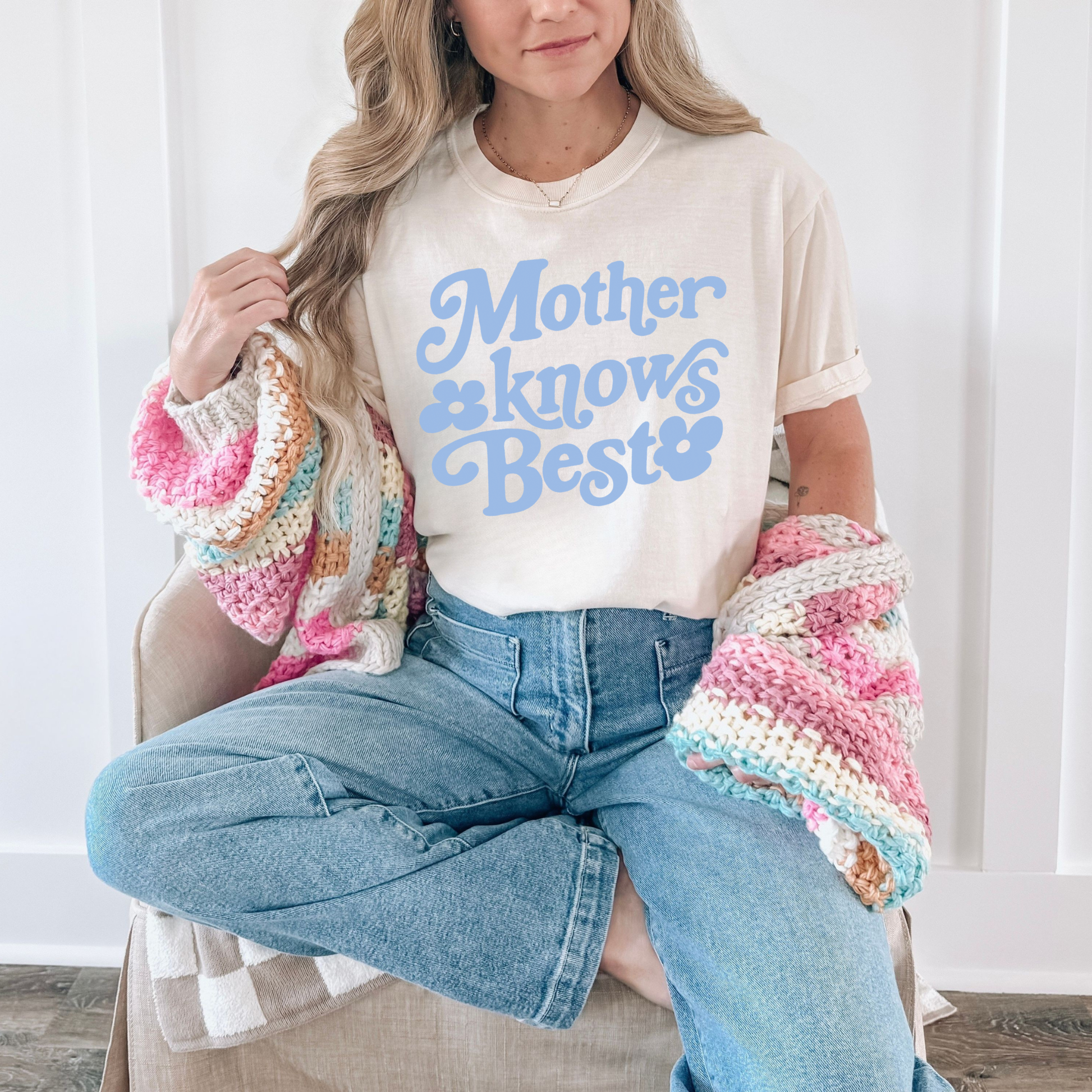 Woman wearing ivory Mother Knows Best retro graphic tee with pastel lettering