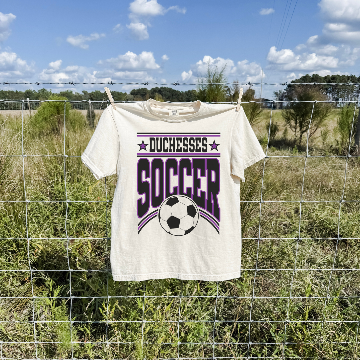 duchesses soccer shirt styled outdoors hanging on fence casual game day outfit