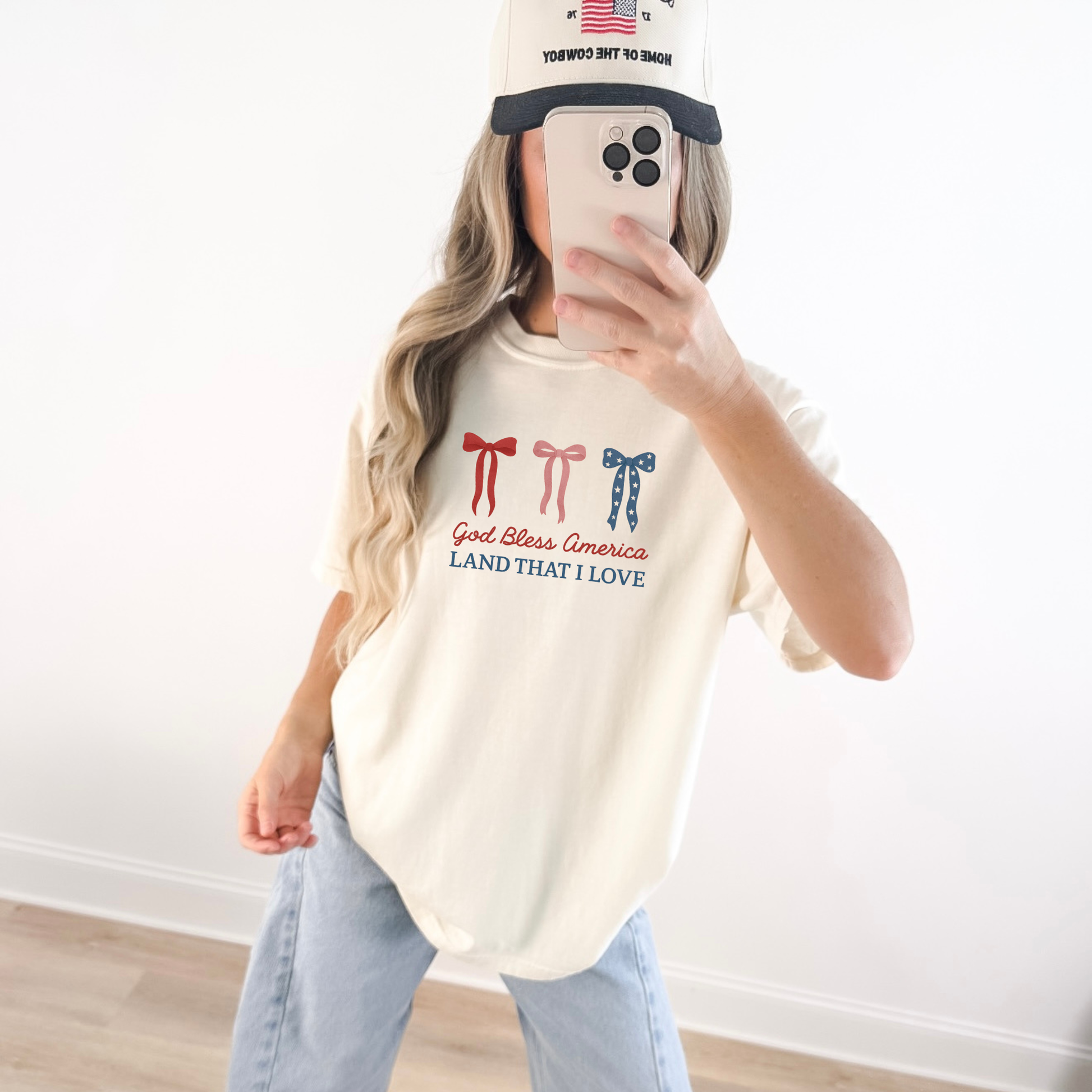 Woman wearing God Bless America bow graphic tee with red white and blue bows