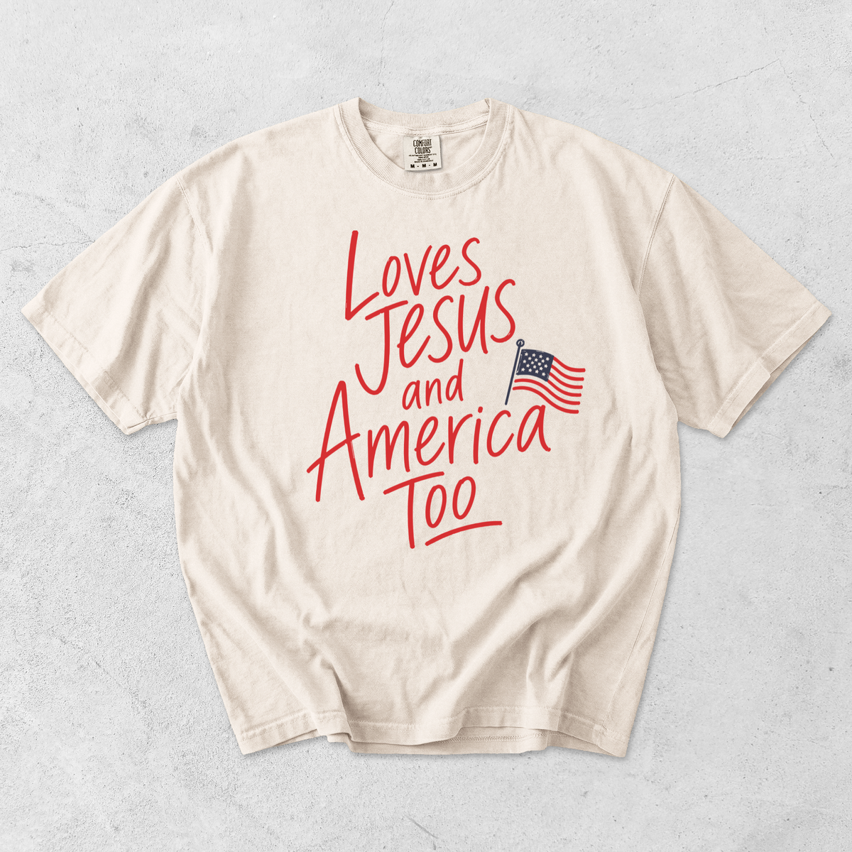 Ivory Comfort Colors t-shirt featuring Loves Jesus and America Too faith based patriotic graphic with American flag