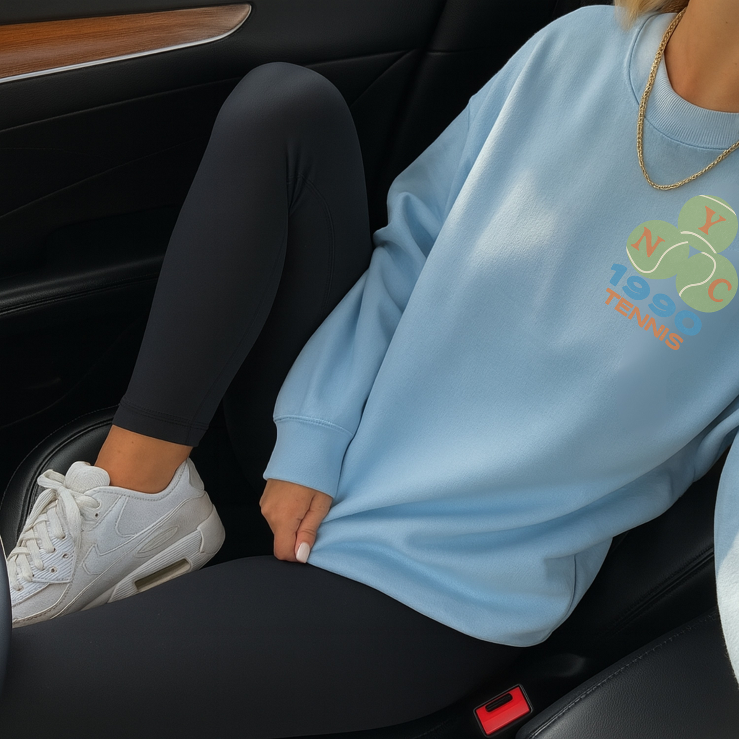 Light blue tennis crewneck sweatshirt with chest logo styled casually