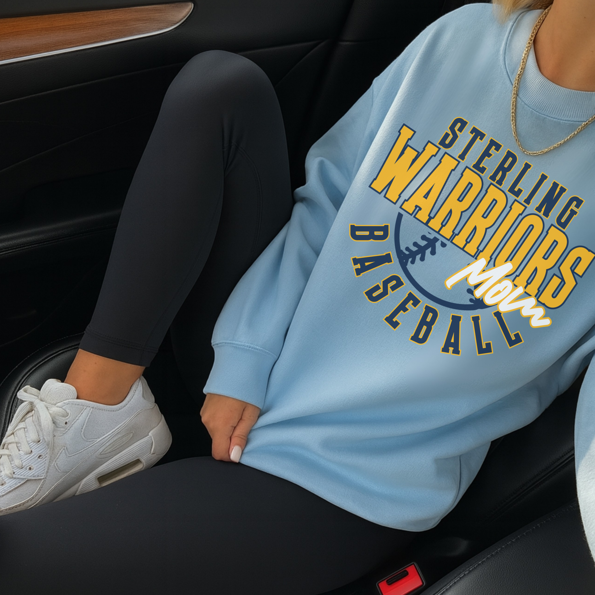 Sterling Warriors Baseball Mom light blue crewneck sweatshirt styled with black leggings and white sneakers casual game day outfit in car