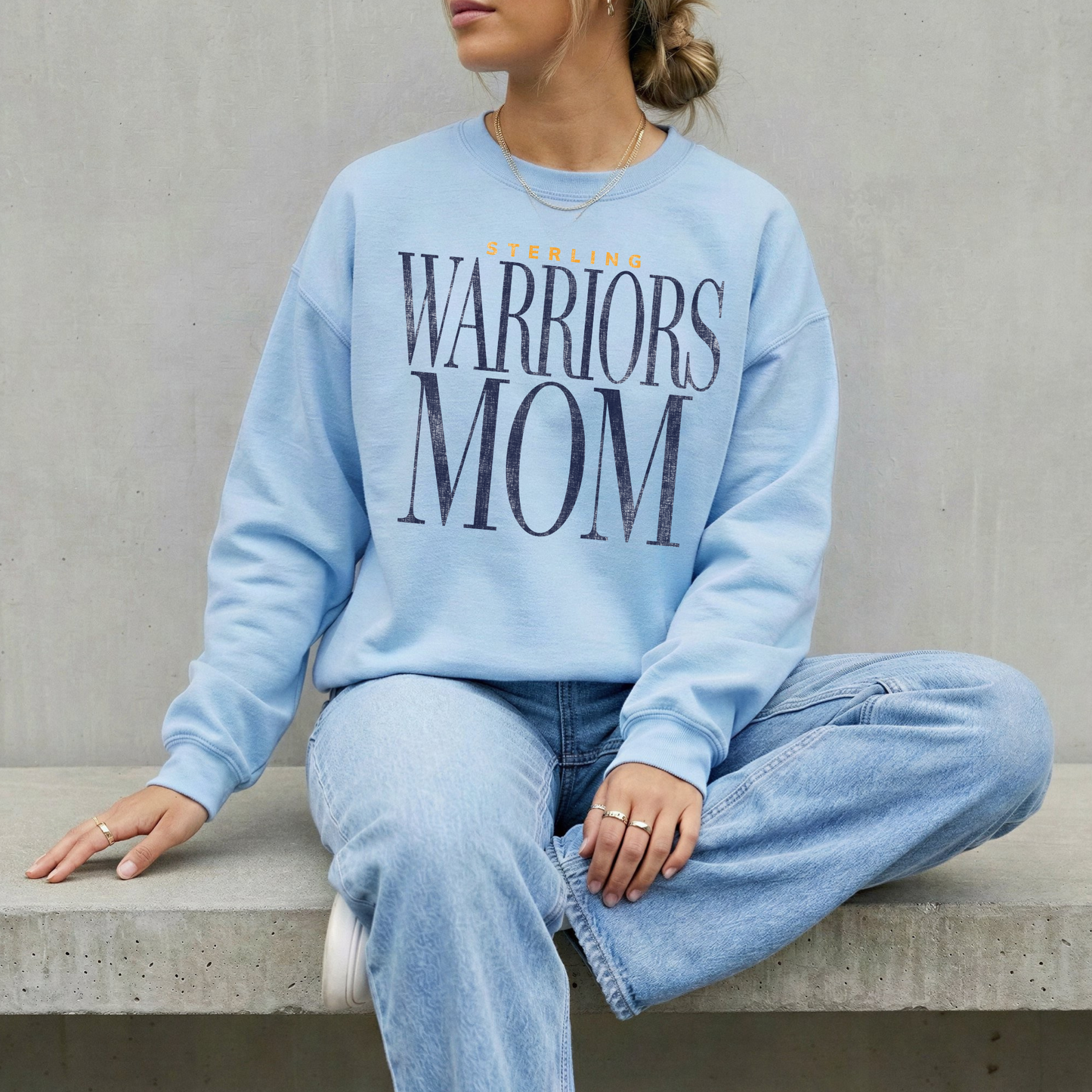 Sterling Warriors Mom light blue crewneck sweatshirt worn by woman with light denim jeans neutral aesthetic sporty outfit