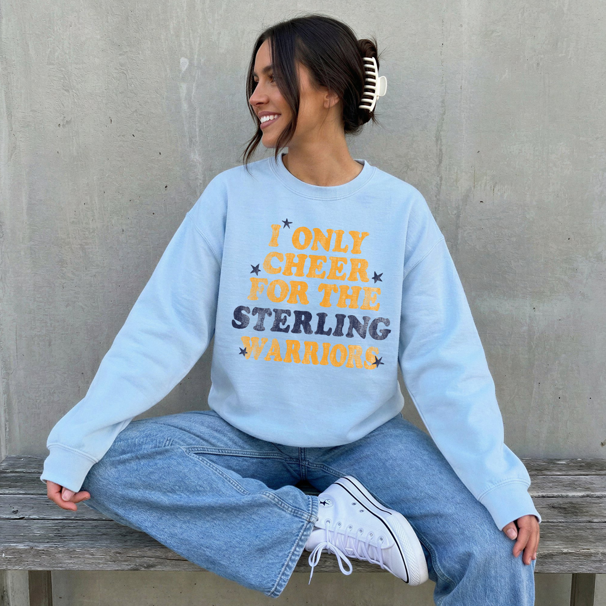 sterling warriors sweatshirt worn by woman smiling sitting on bench casual cozy game day outfit