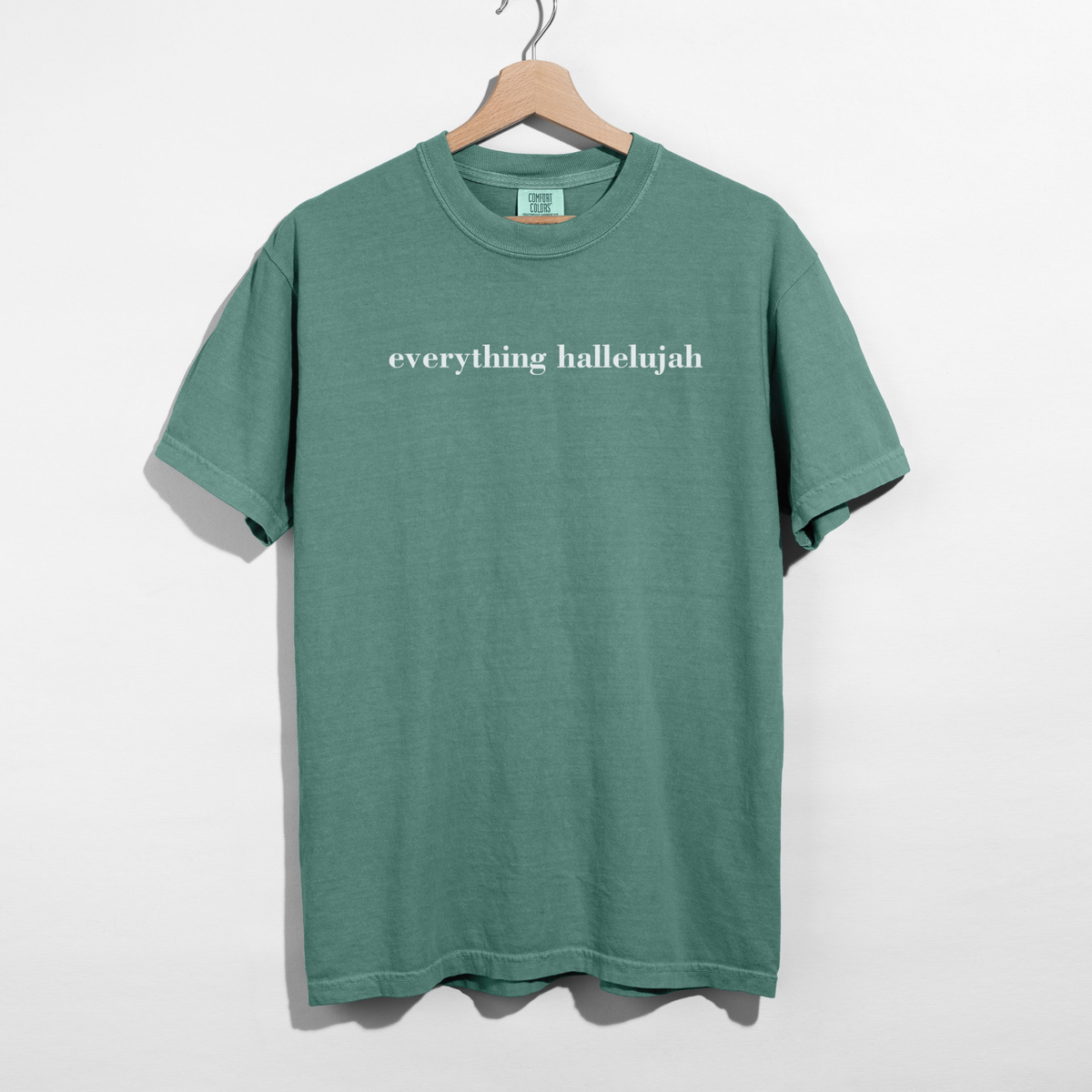 Light green Everything Hallelujah minimalist Christian t-shirt styled with cream shorts and gold jewelry
