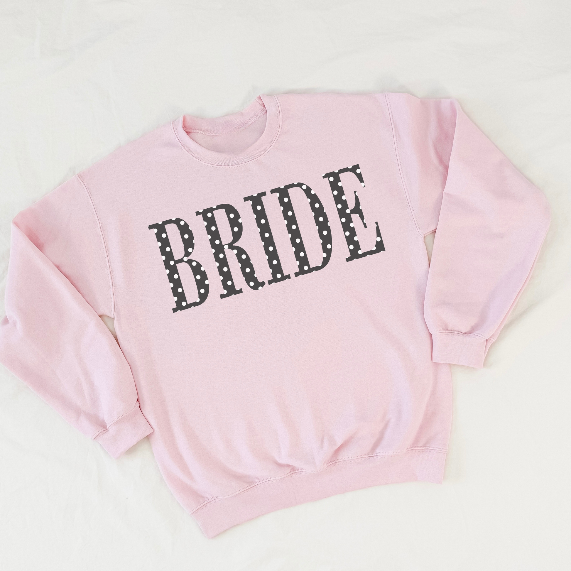 Pink BRIDE polka dot crewneck sweatshirt flat lay on white background
