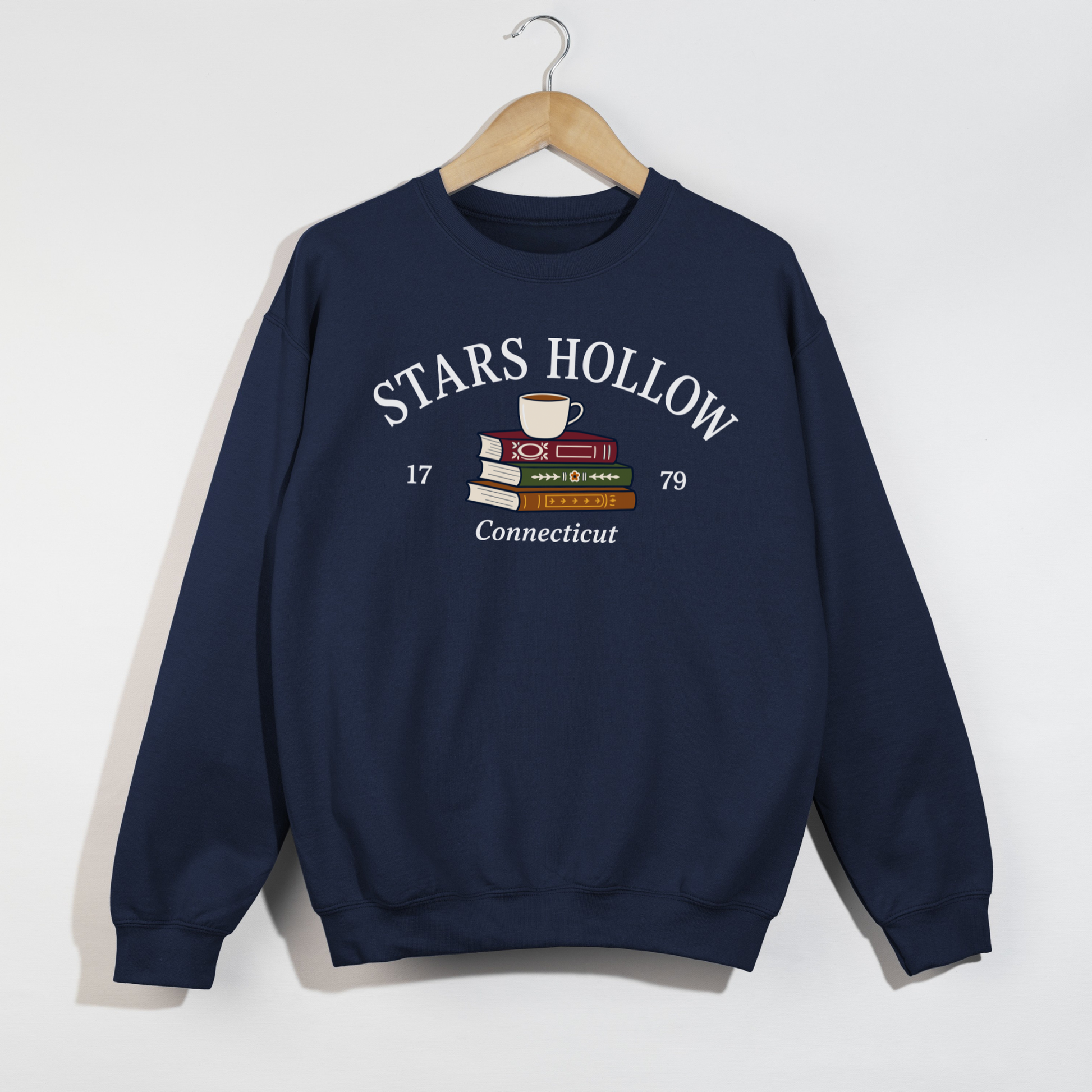 Navy Stars Hollow Connecticut crewneck sweatshirt with a cozy books and coffee graphic.