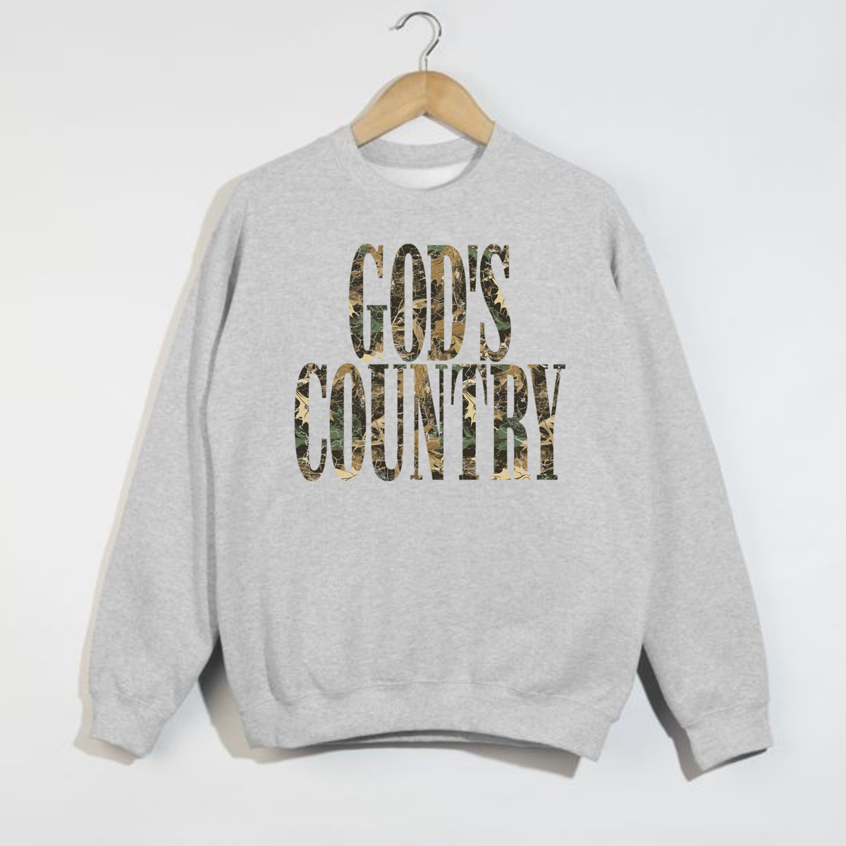 Heather grey God’s Country crewneck sweatshirt with oversized woodland camouflage graphic lettering