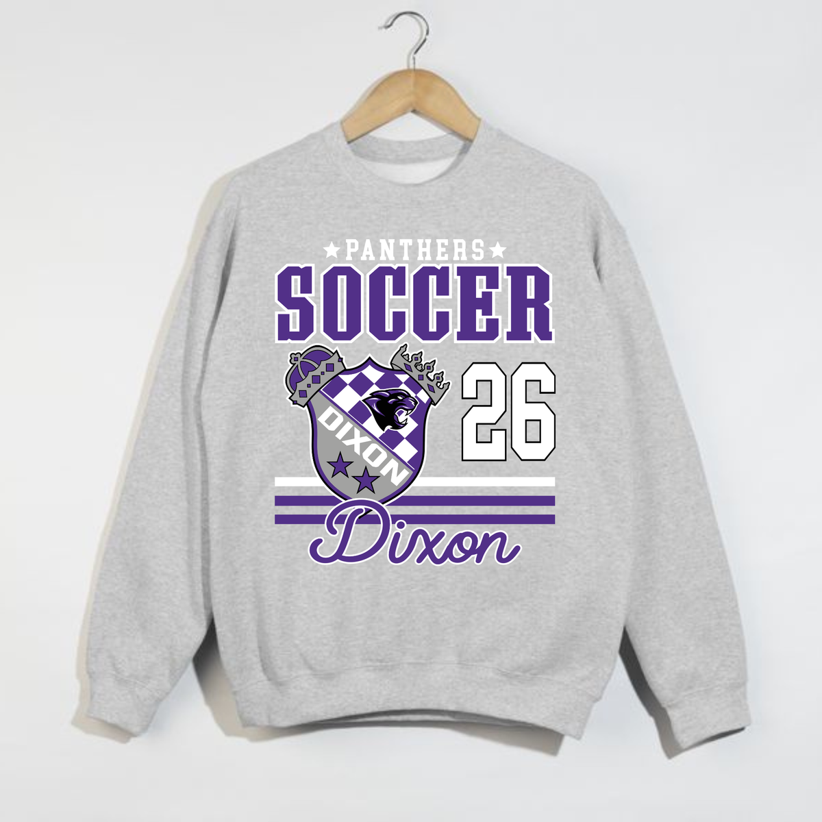 Oatmeal heather Dixon Panthers Soccer 2026 crewneck sweatshirt featuring purple varsity lettering, Panthers crest and Dixon script.