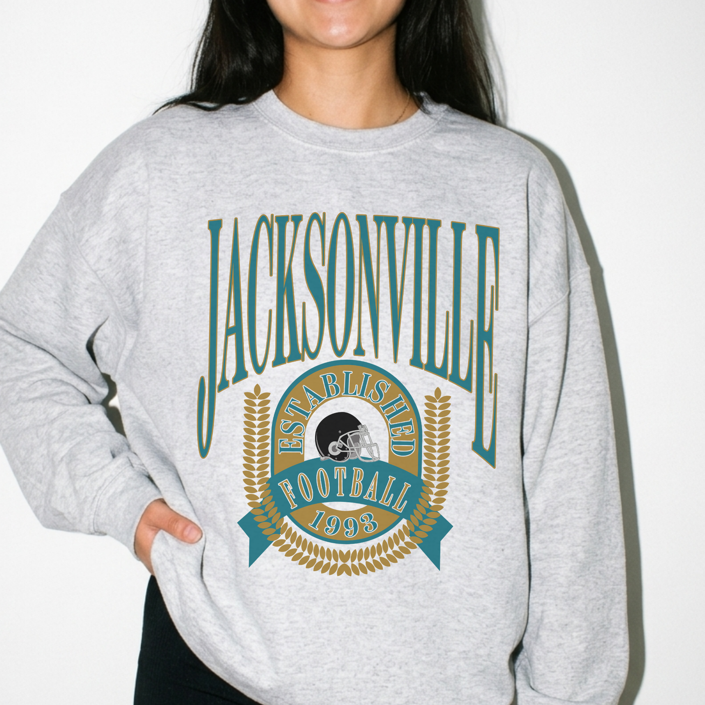 Woman wearing heather gray Jacksonville football sweatshirt with vintage teal and gold established 1993 graphic