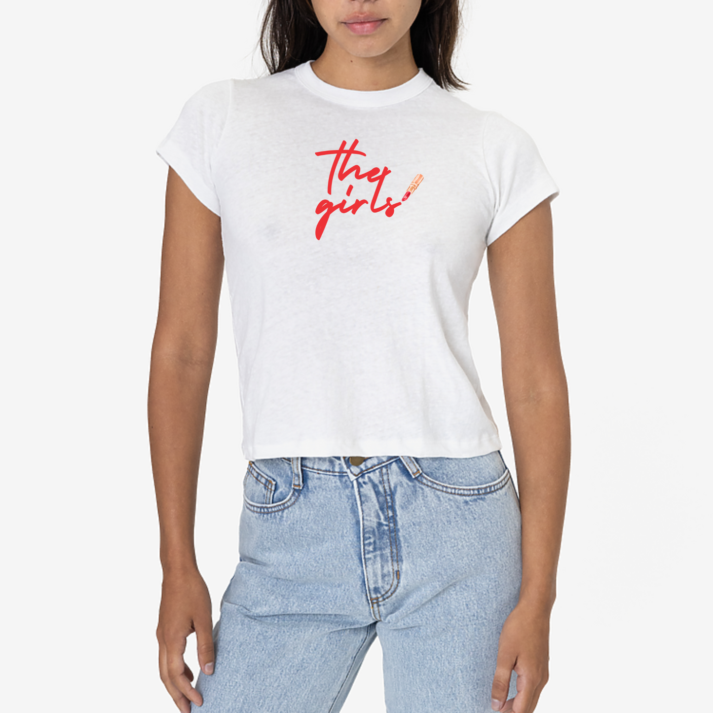 Person wearing a white t-shirt with 'the girls' text and light blue jeans on a white background
