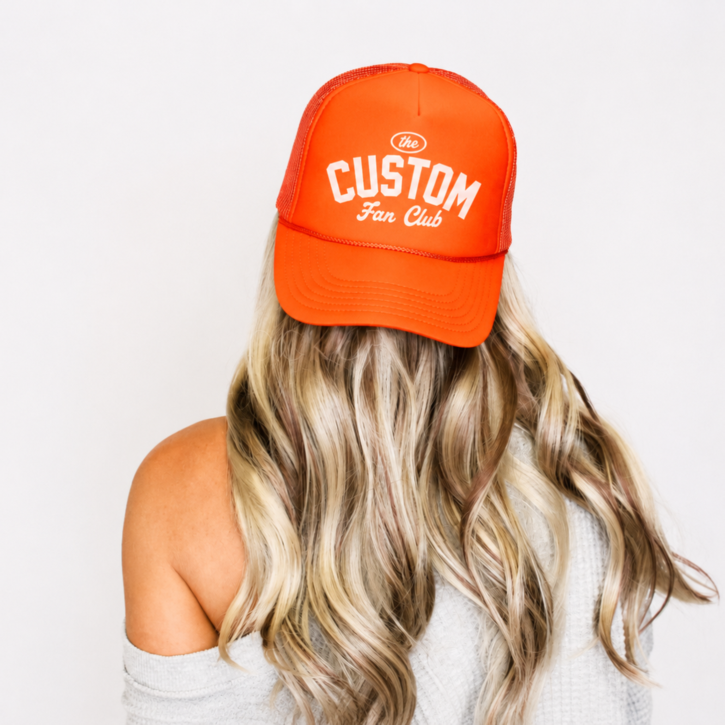 Neon orange personalized Custom Fan Club trucker hat lifestyle mockup.