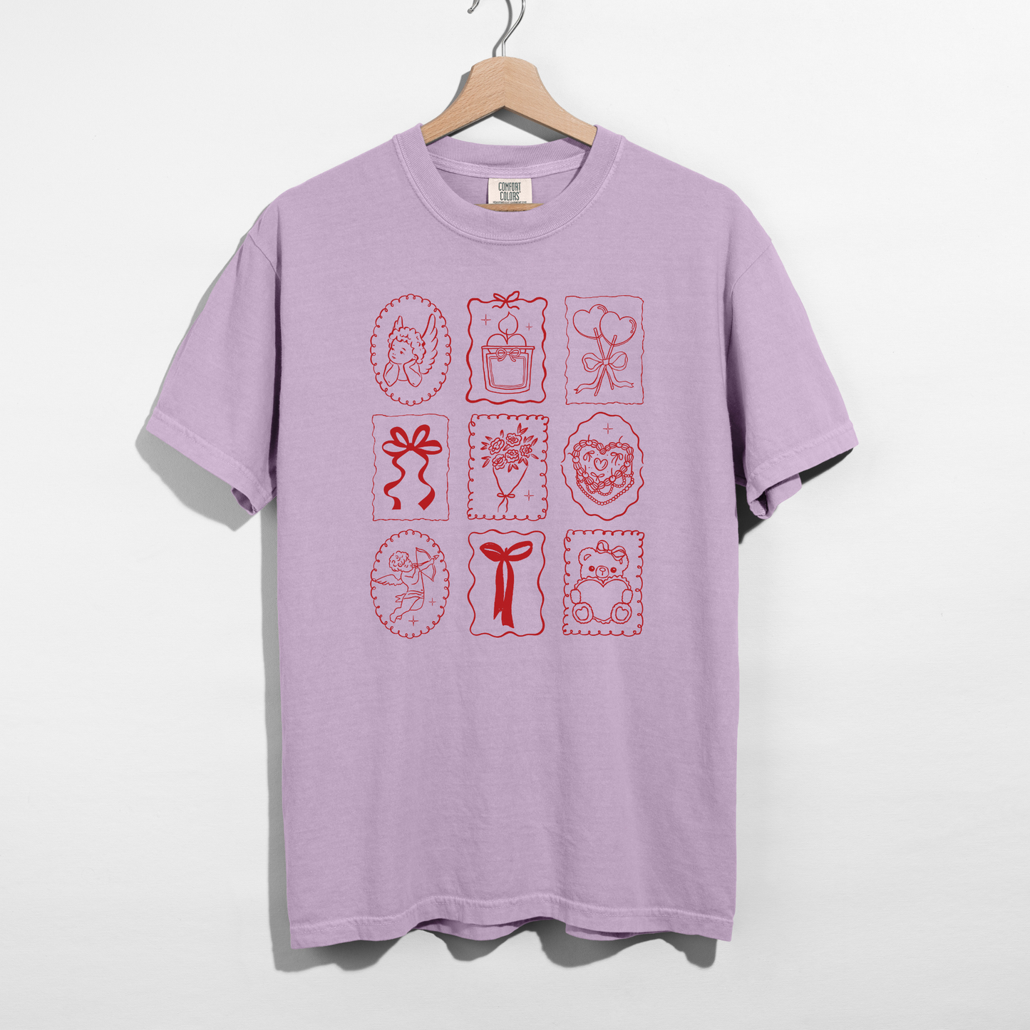 Orchid Comfort Colors tee with red Valentine stamp icons graphic on hanger.