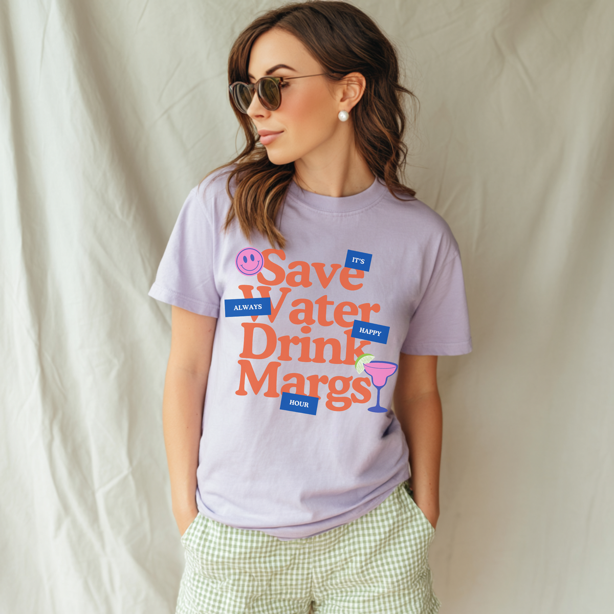 Woman wearing a purple t-shirt with a colorful graphic and text against a plain background